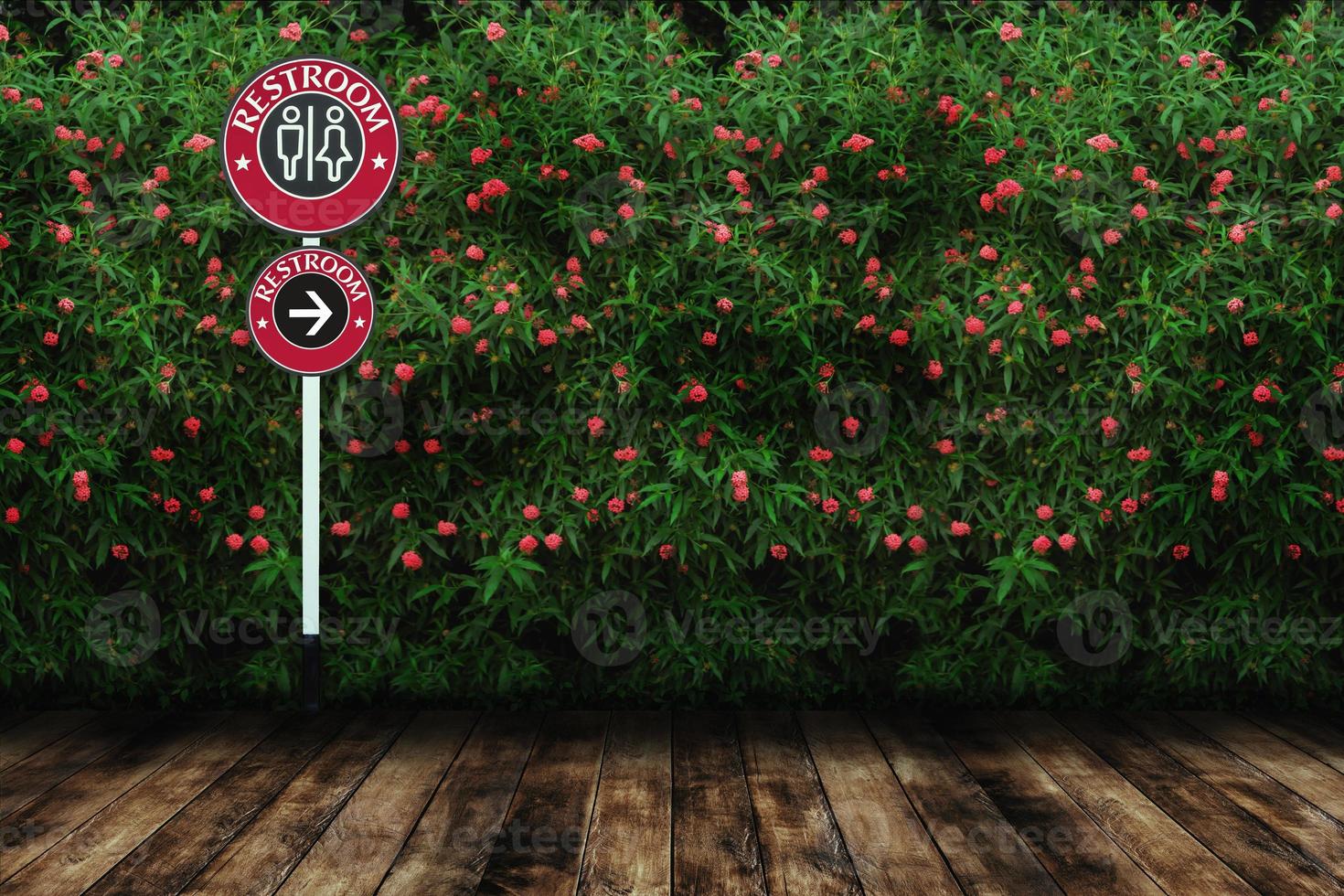 Restroom sign with red flower and green leaves wall background with wood floor. photo