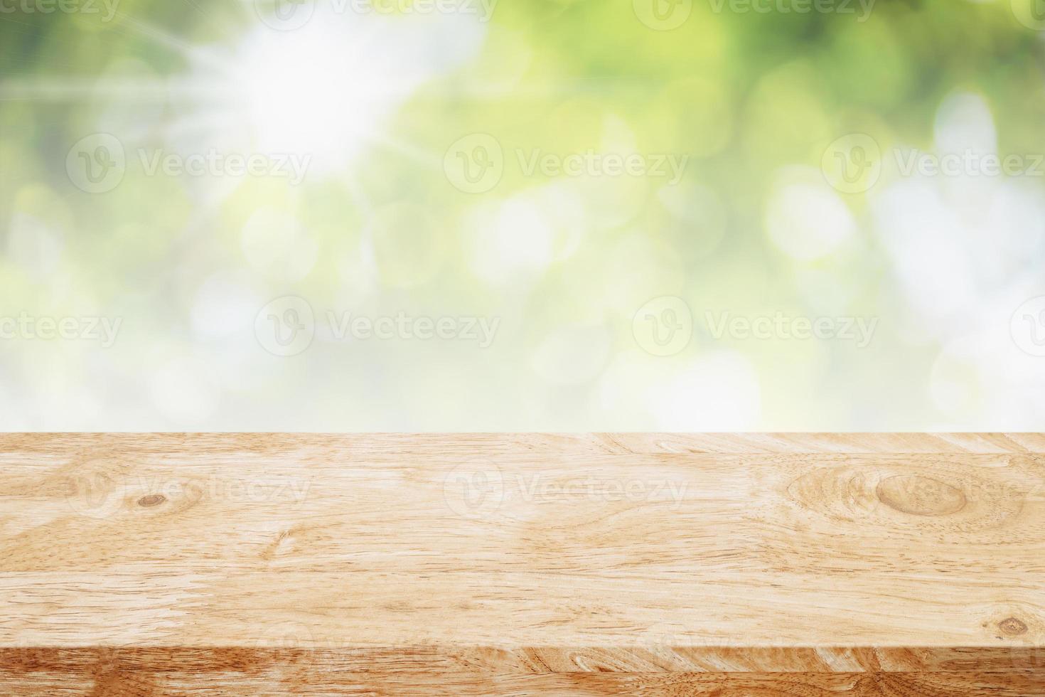 Empty wood table top on abstract blur green garden in the morning background. photo