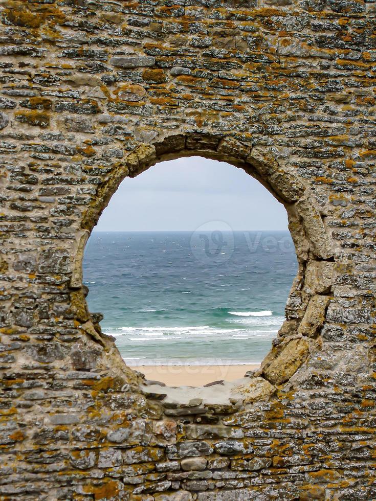 looking at the lake through a hole in the wall photo