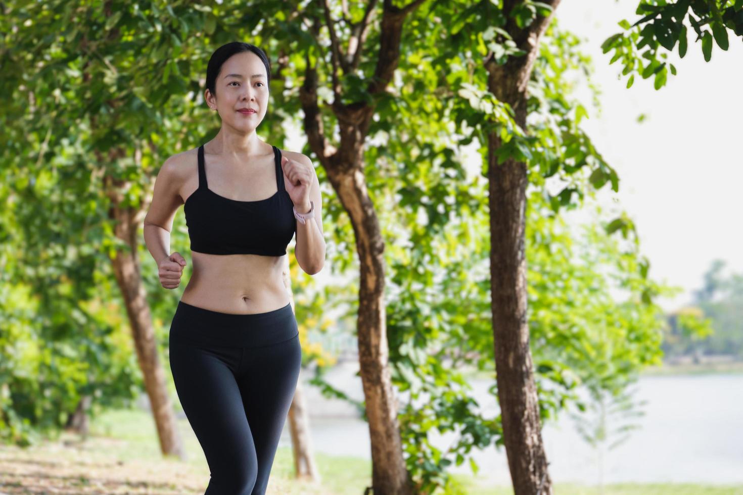 Woman running outside in park in  beautiful summer. photo