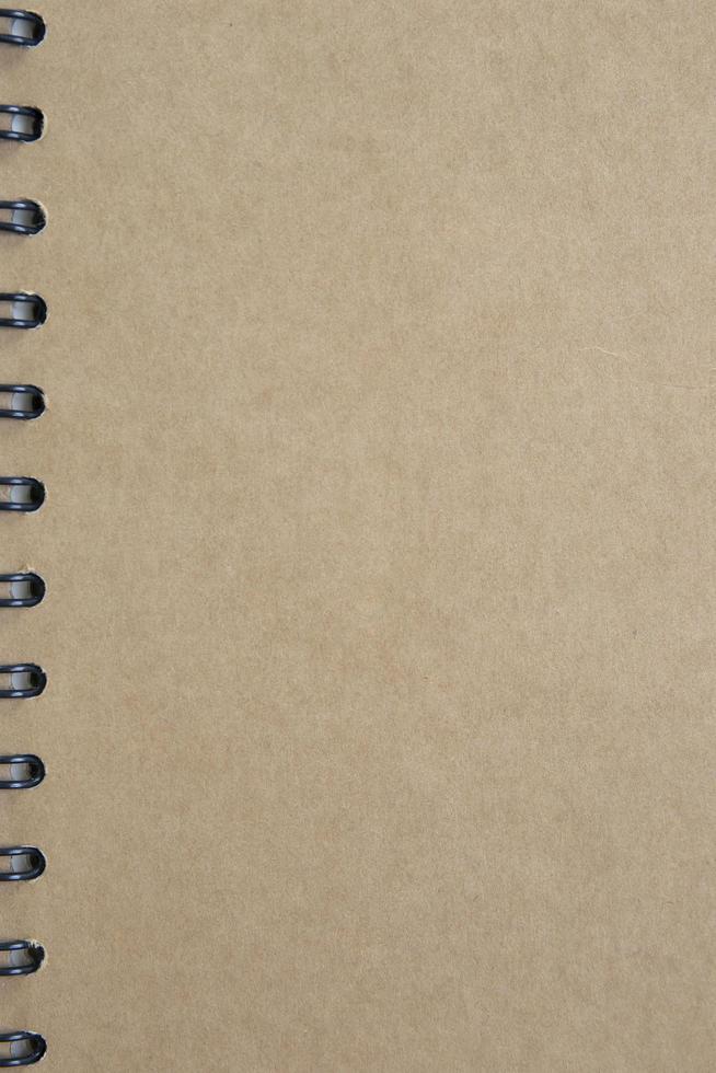 Brown paper background on the cover of the notebook. photo