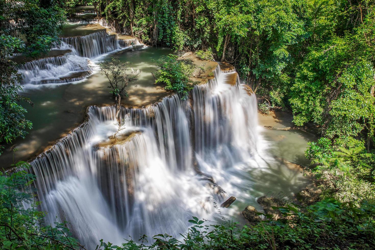 Beautiful waterfall nature scenery of deep forest in summer day photo