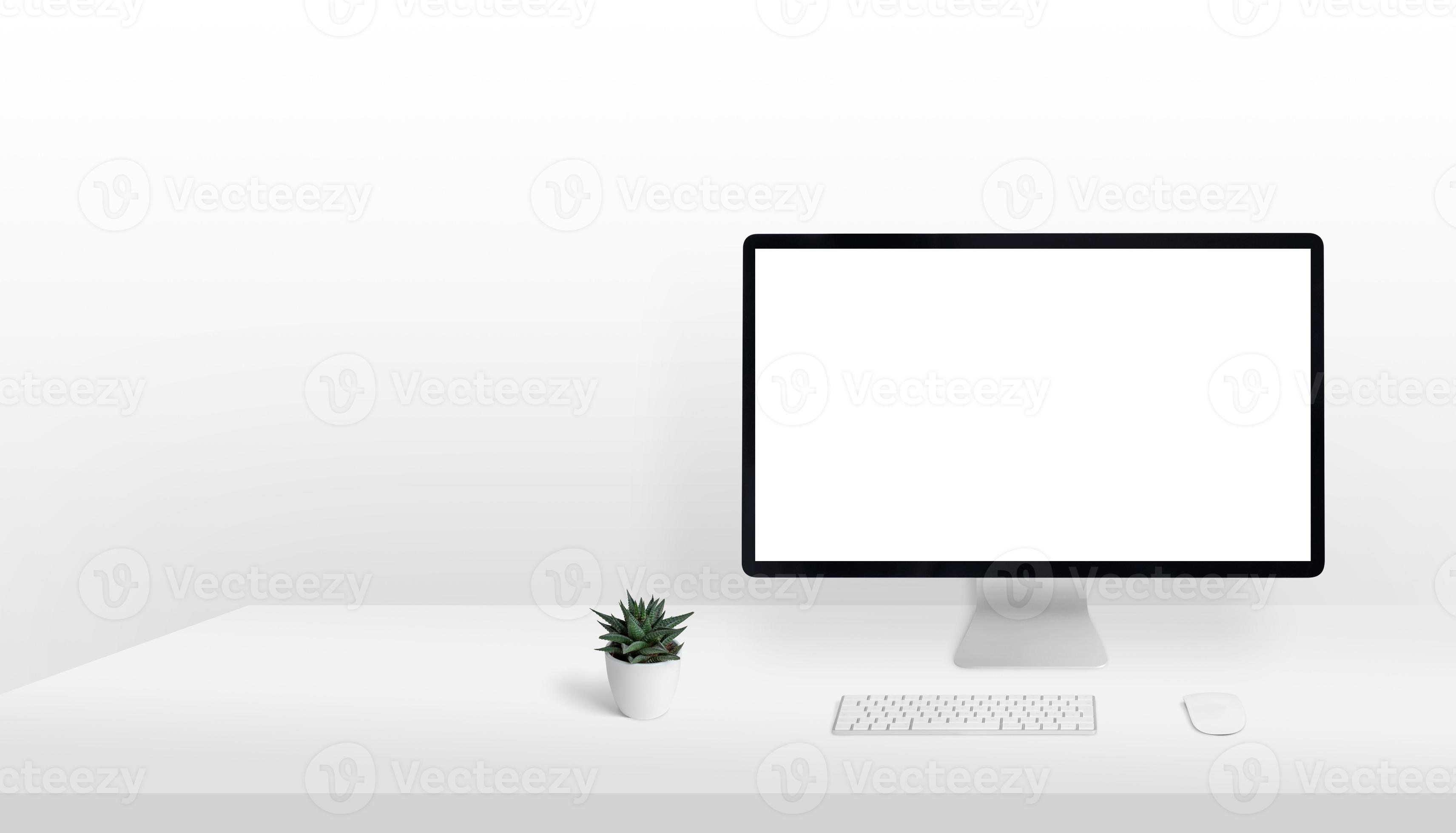 Computer display mockup on work desk with copy space beside. Clean