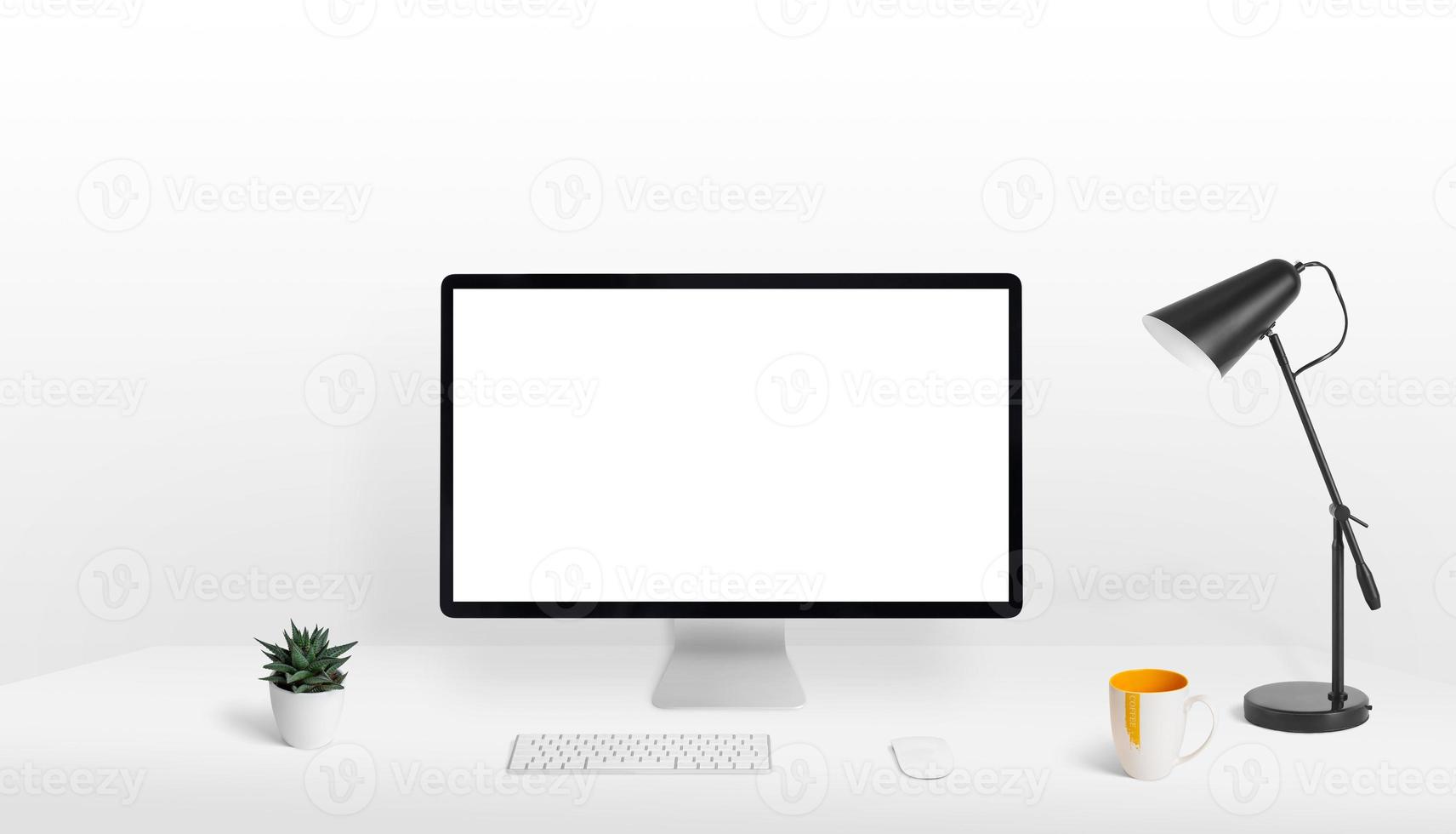 Computer display mockup on work desk. Blank, white, isolated screen for web page presentation. Clean, fla composition photo