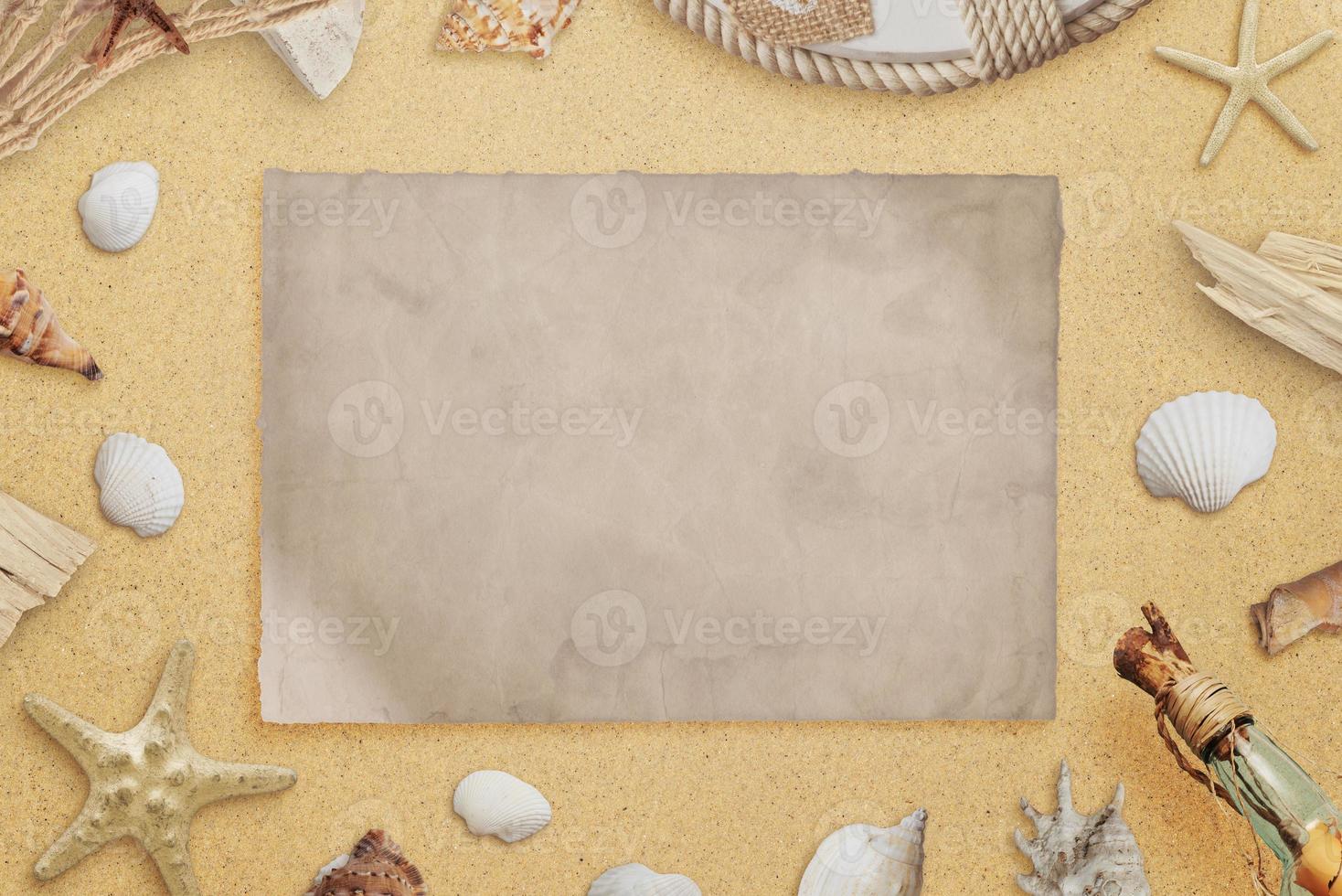 Clean old paper on beach surrounded with seashells and shipwrecks parts. Copy space. Top view, flat lay composition photo