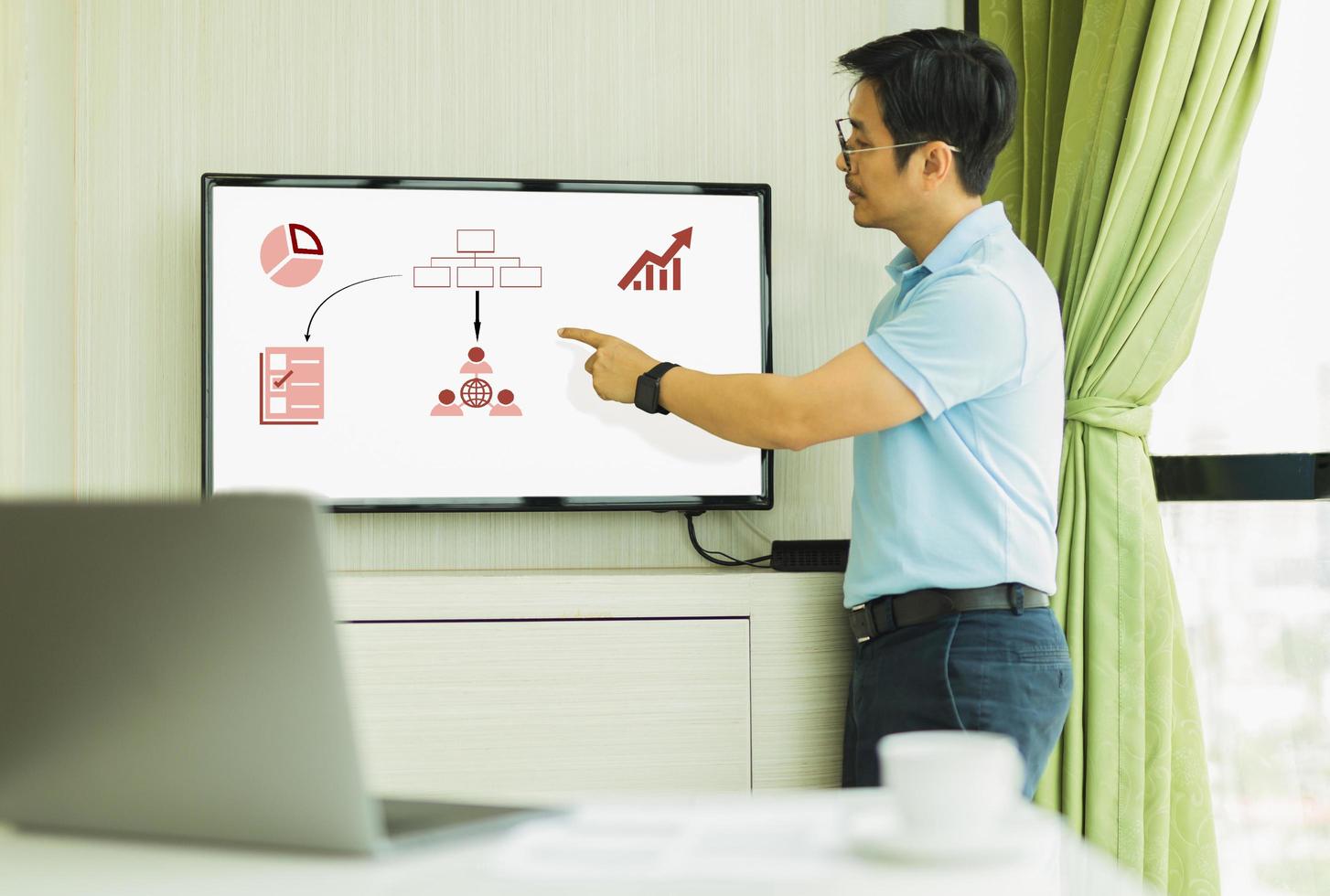 Businessman presention in conference room with hand pointing at screen . photo