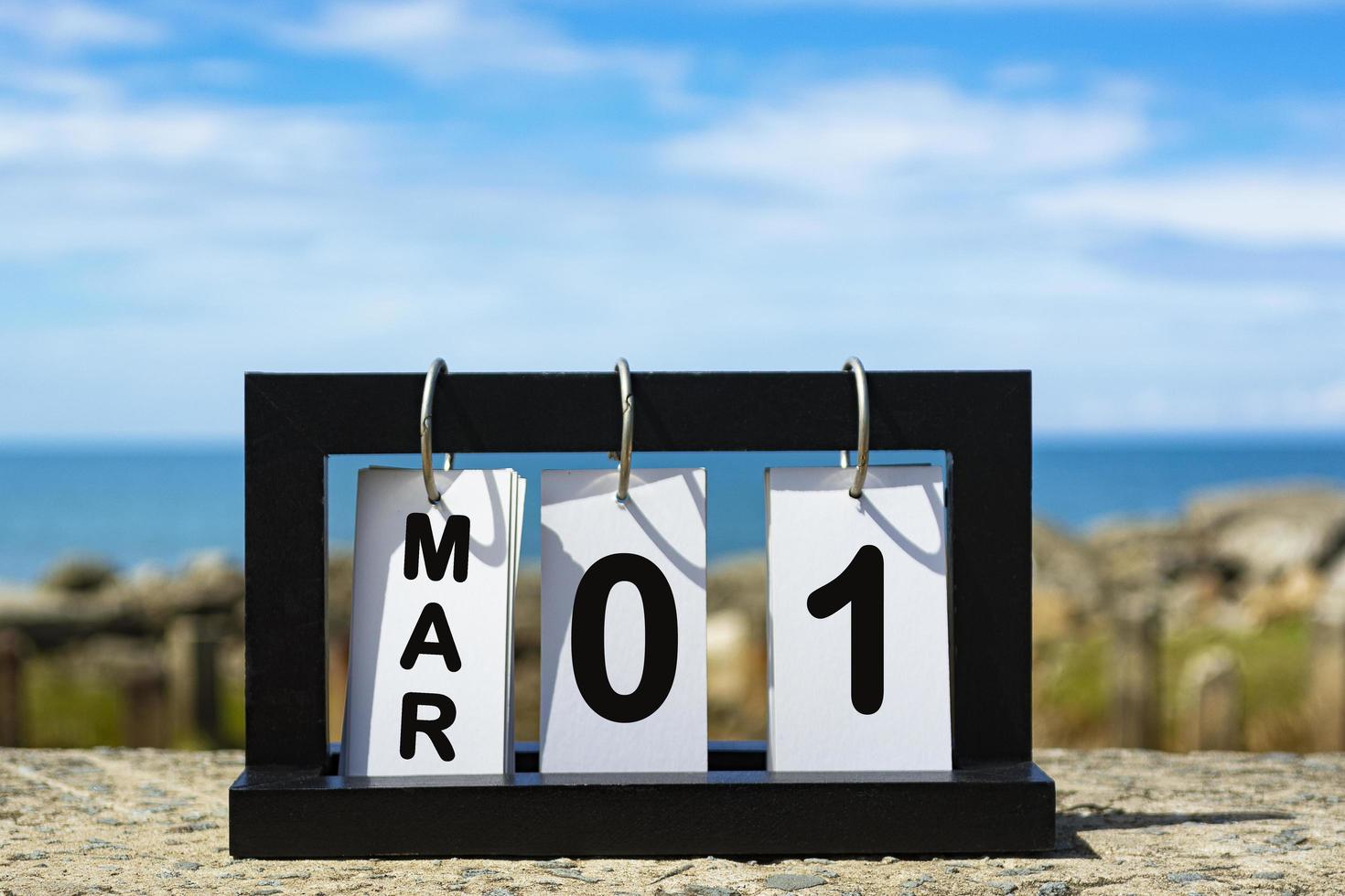 Mar 01 calendar date text on wooden frame with blurred background of ocean photo