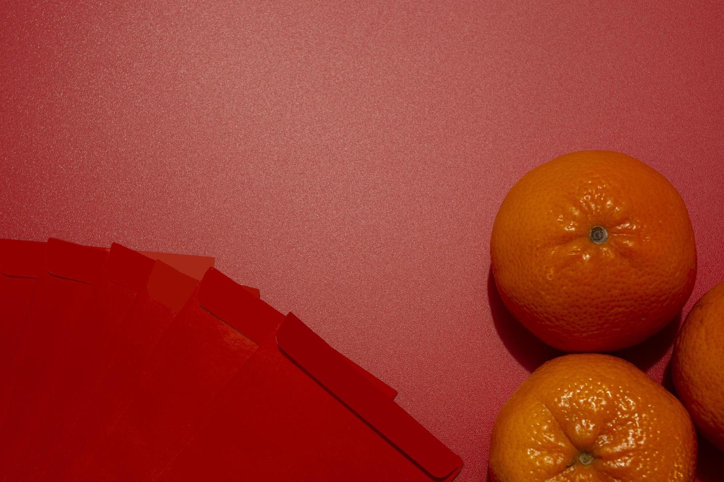 Chinese New Year Concept - Mandarin oranges and red packet photo