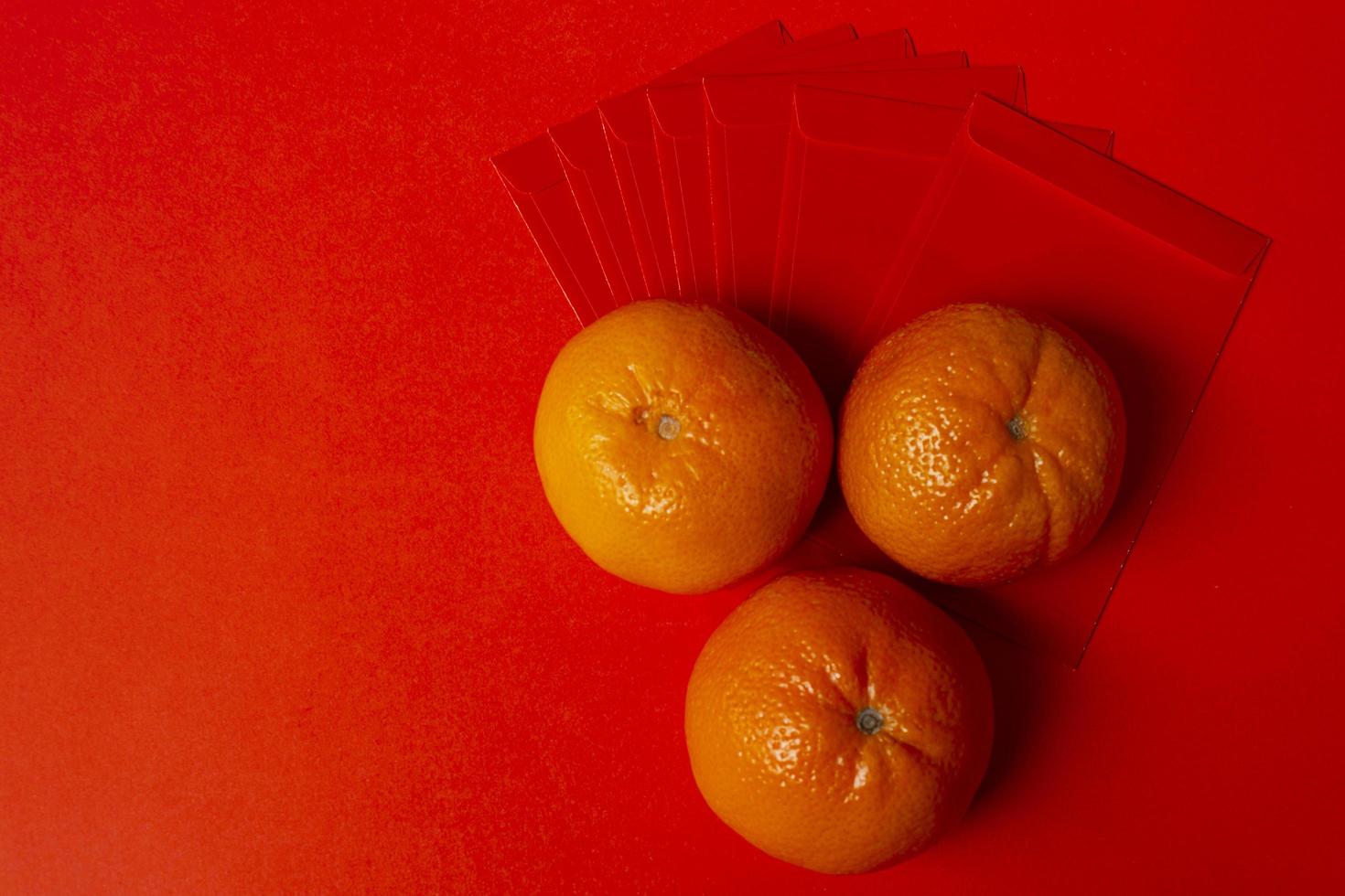 Chinese New Year Concept - Mandarin oranges and red packet photo