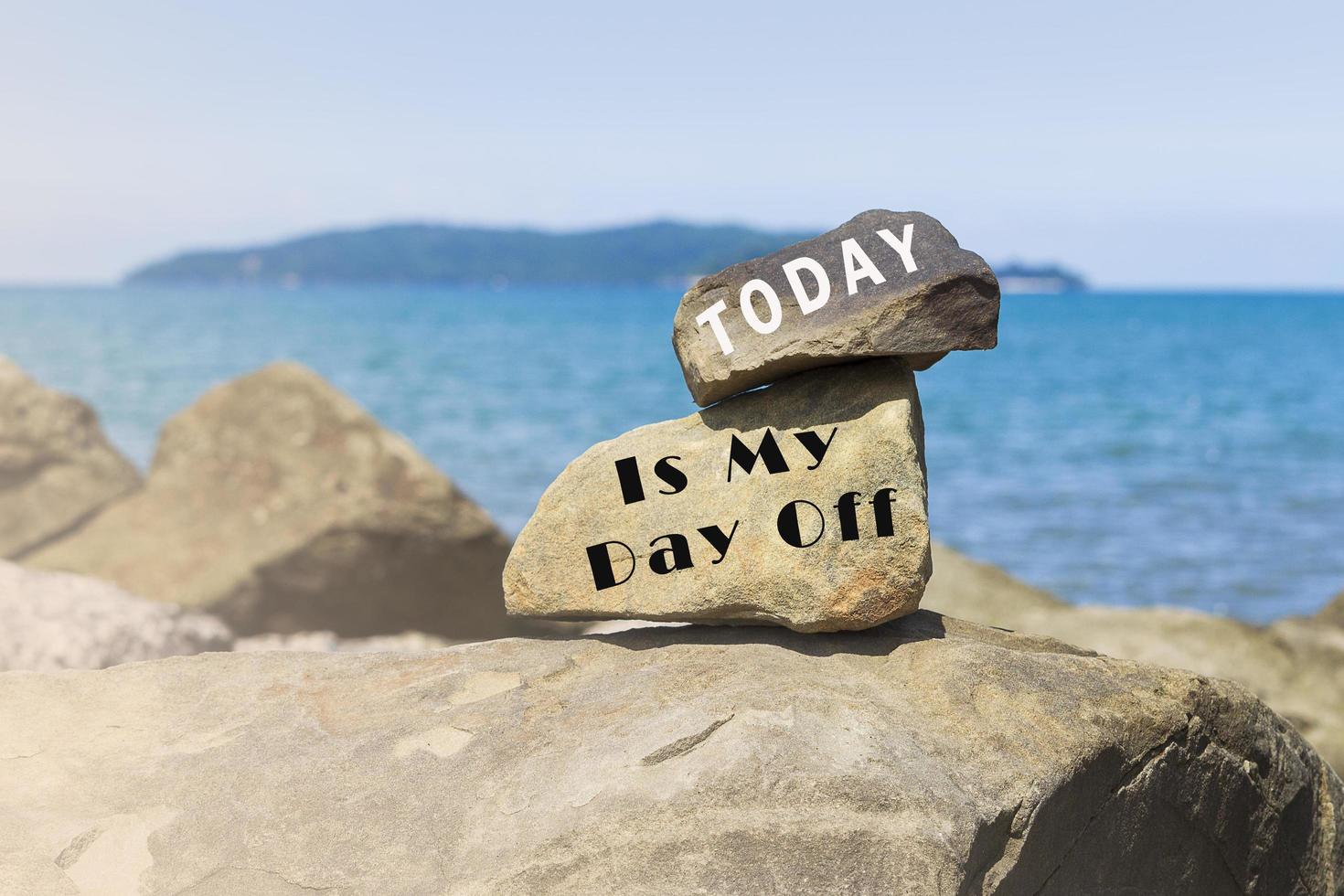 Inspirational text written on stones at the beach with sea view photo