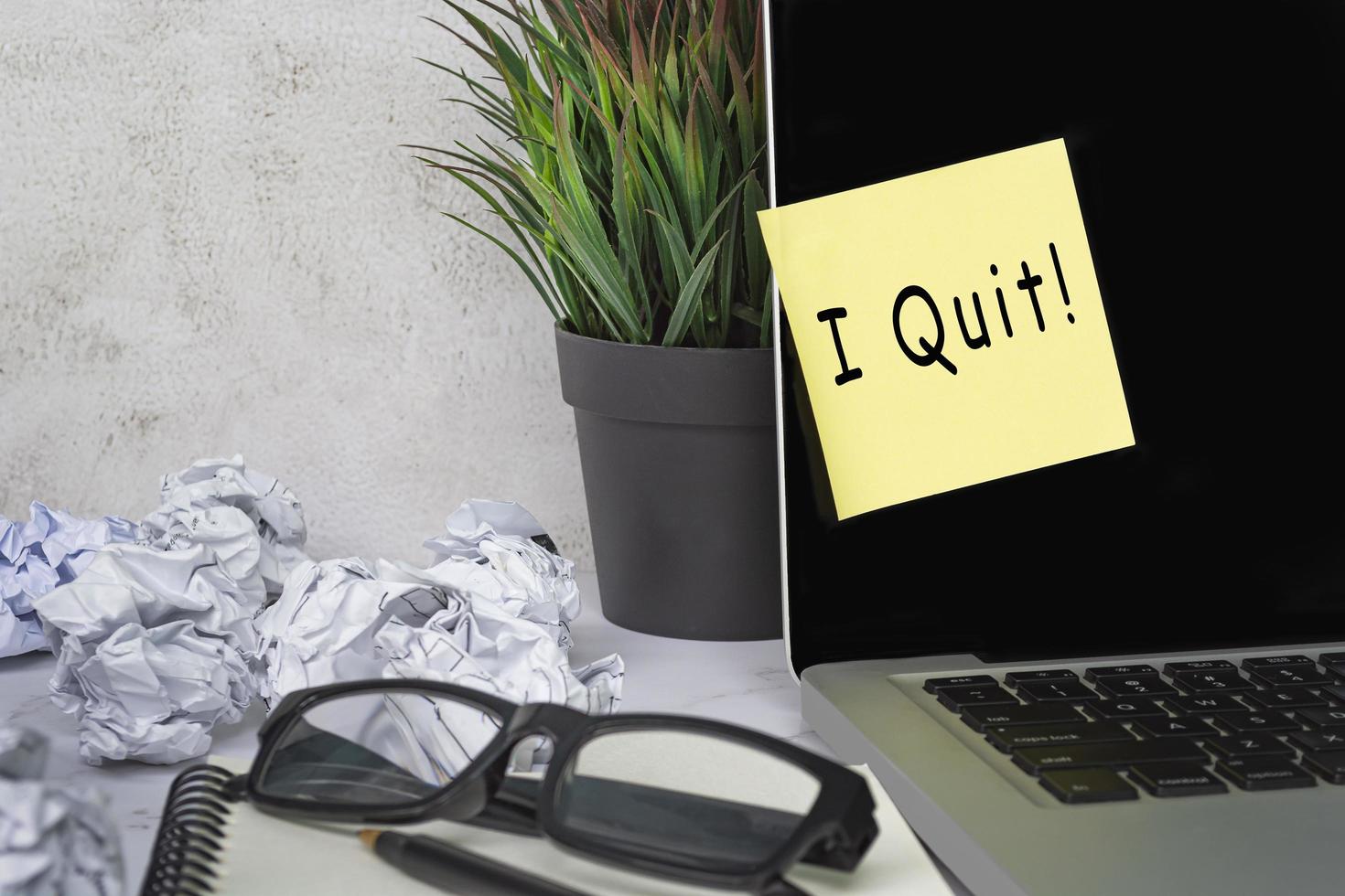 I quit text on sticky note on laptop . Concept of decision making to quit job. photo