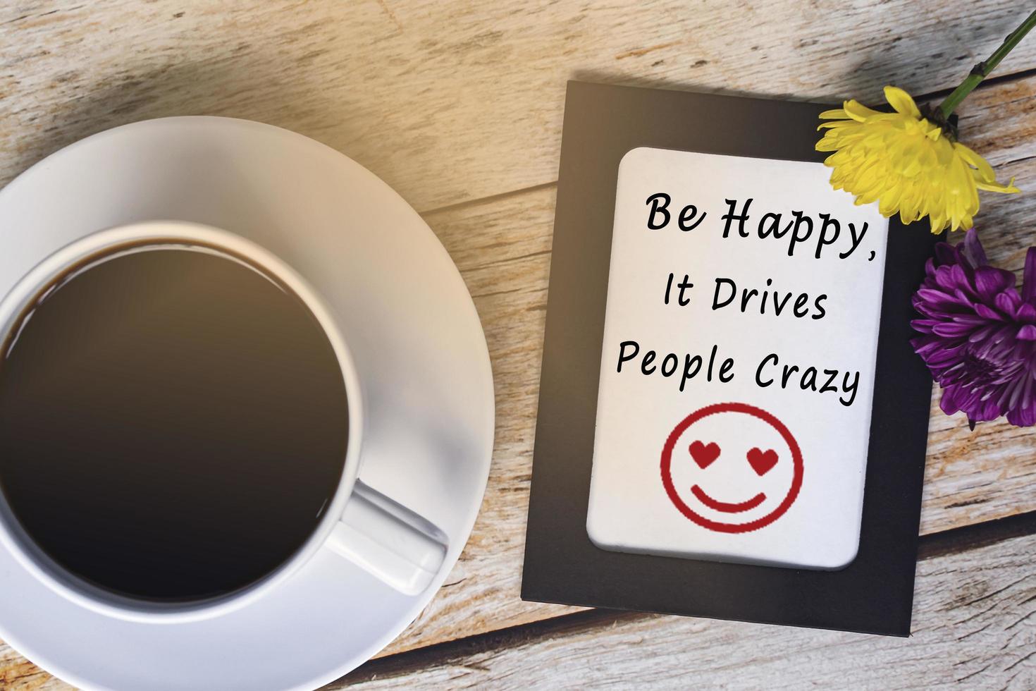 Motivational quote with smile face on chalkboard frame and white coffee cup. photo