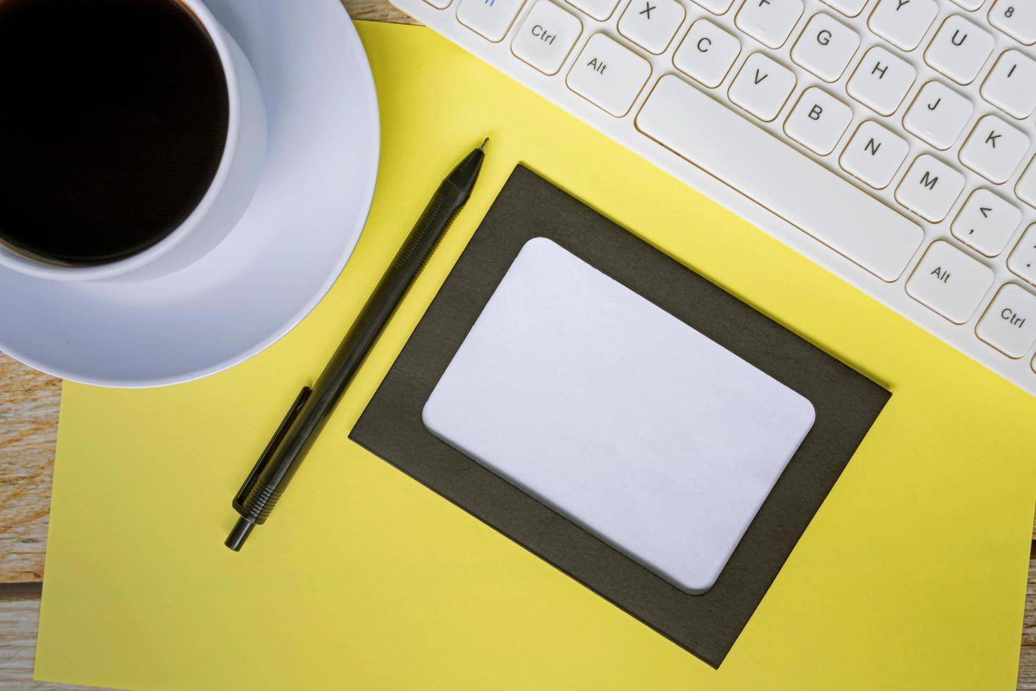 Directly above view of office desk table with yellow background. Copy space. photo