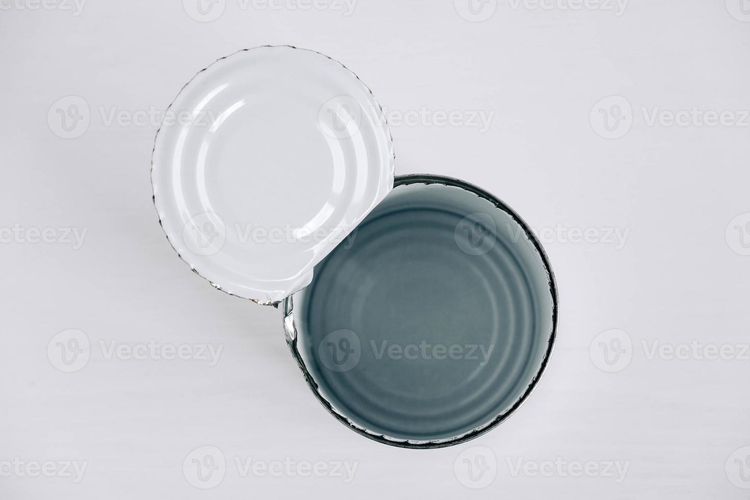 Empty open tin can on a white background photo