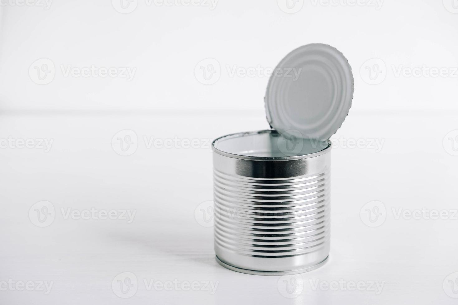 Empty open tin can on a white background photo