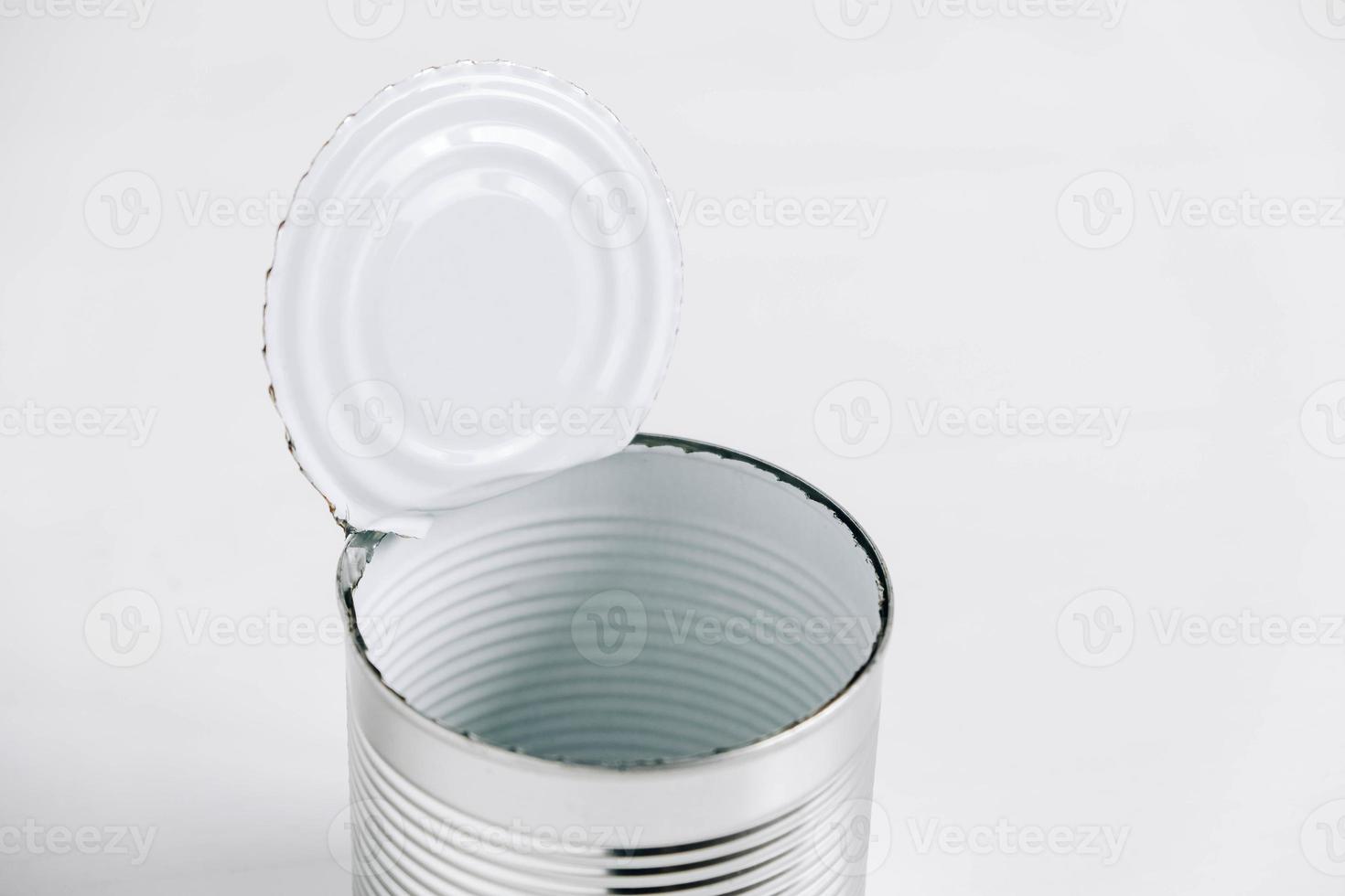 Empty open tin can on a white background photo