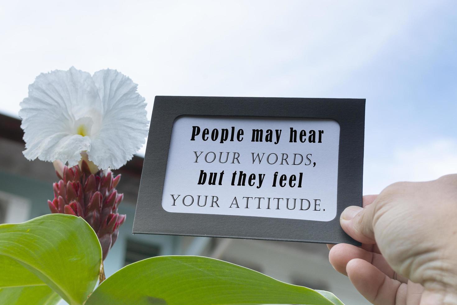 Motivational and inspirational quote on hands holding framed paper with blurred background photo