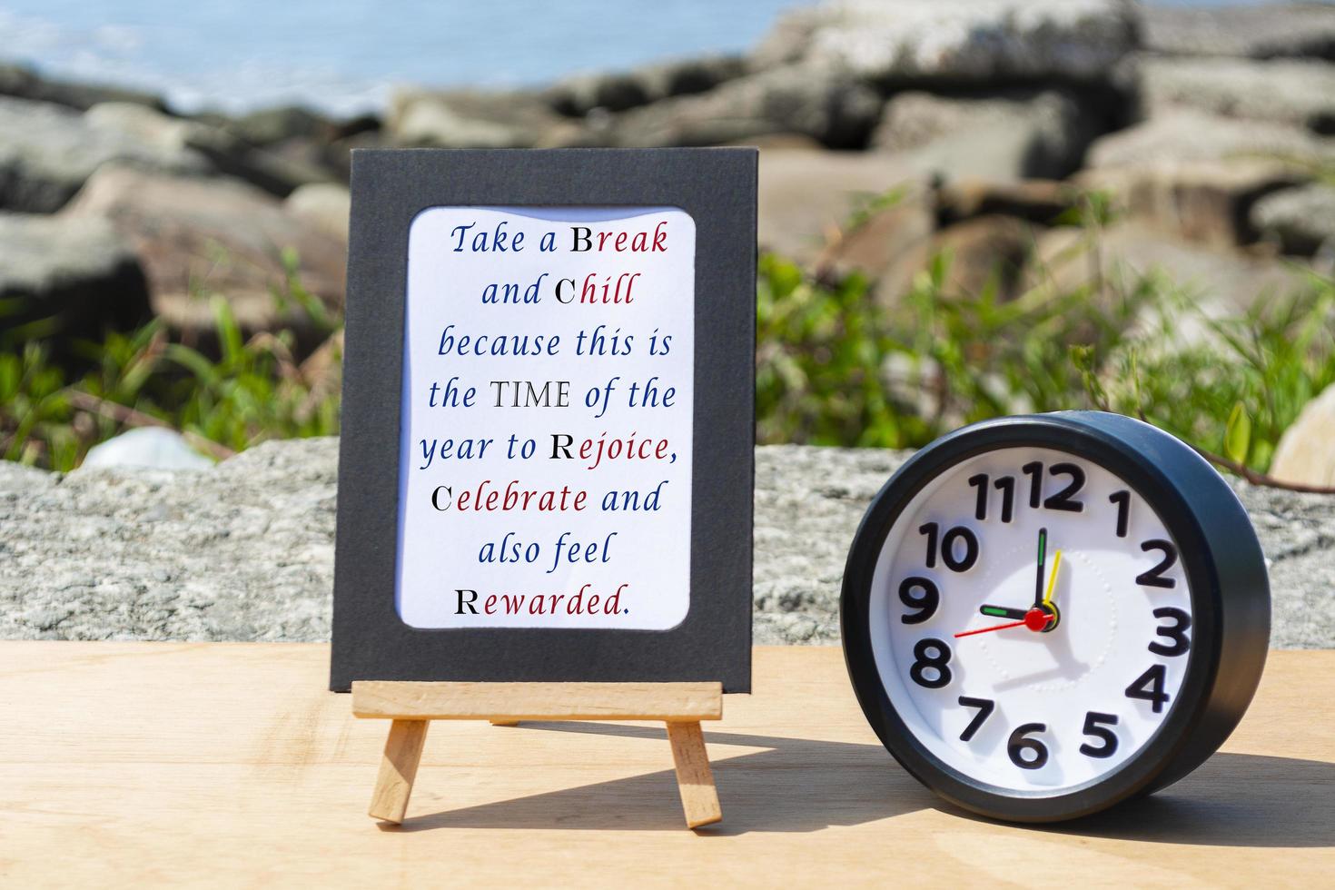 Motivational and Inspirational quote on standing notepad with black alarm clock photo
