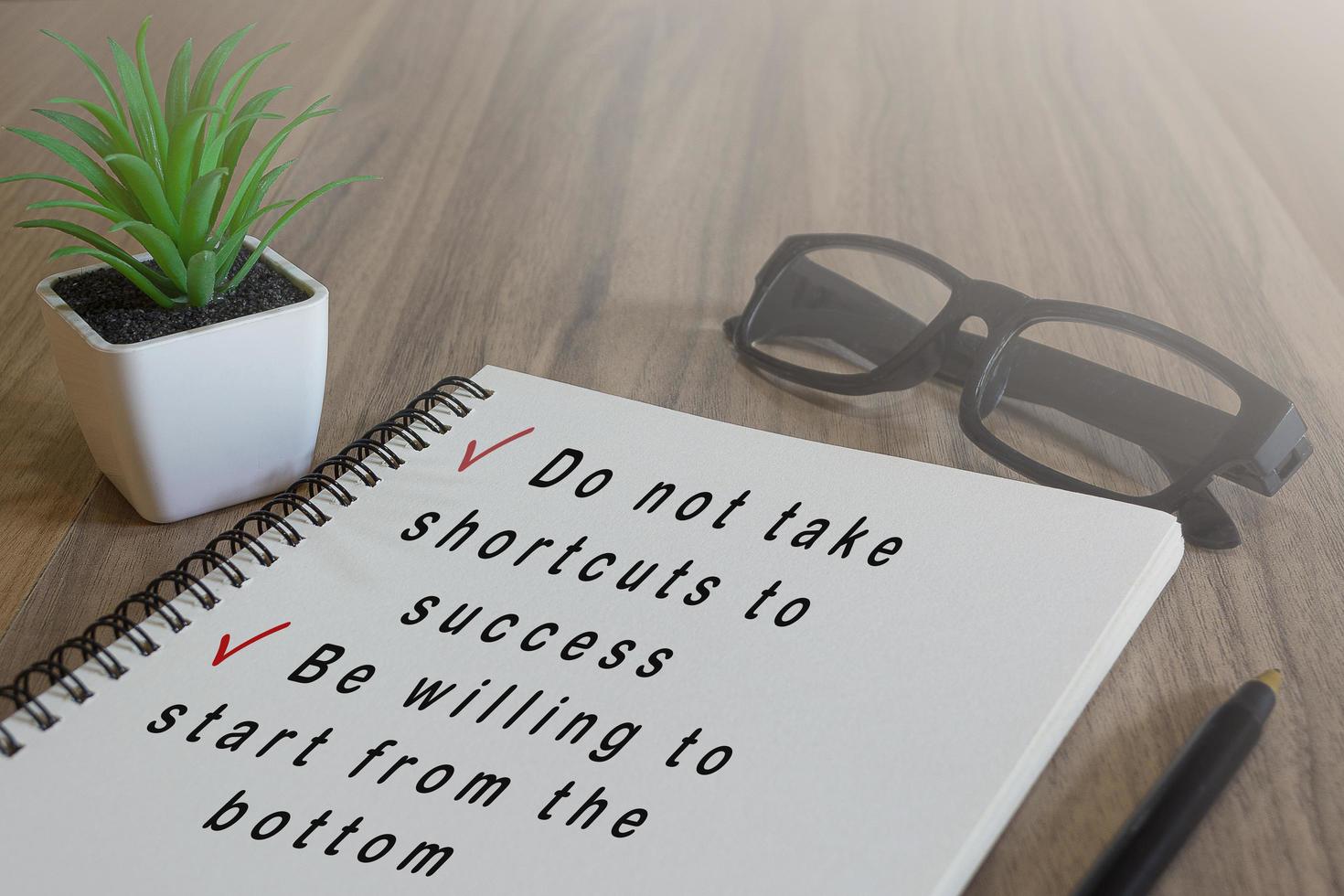 Text on white notepad on wooden desk. Success concept photo