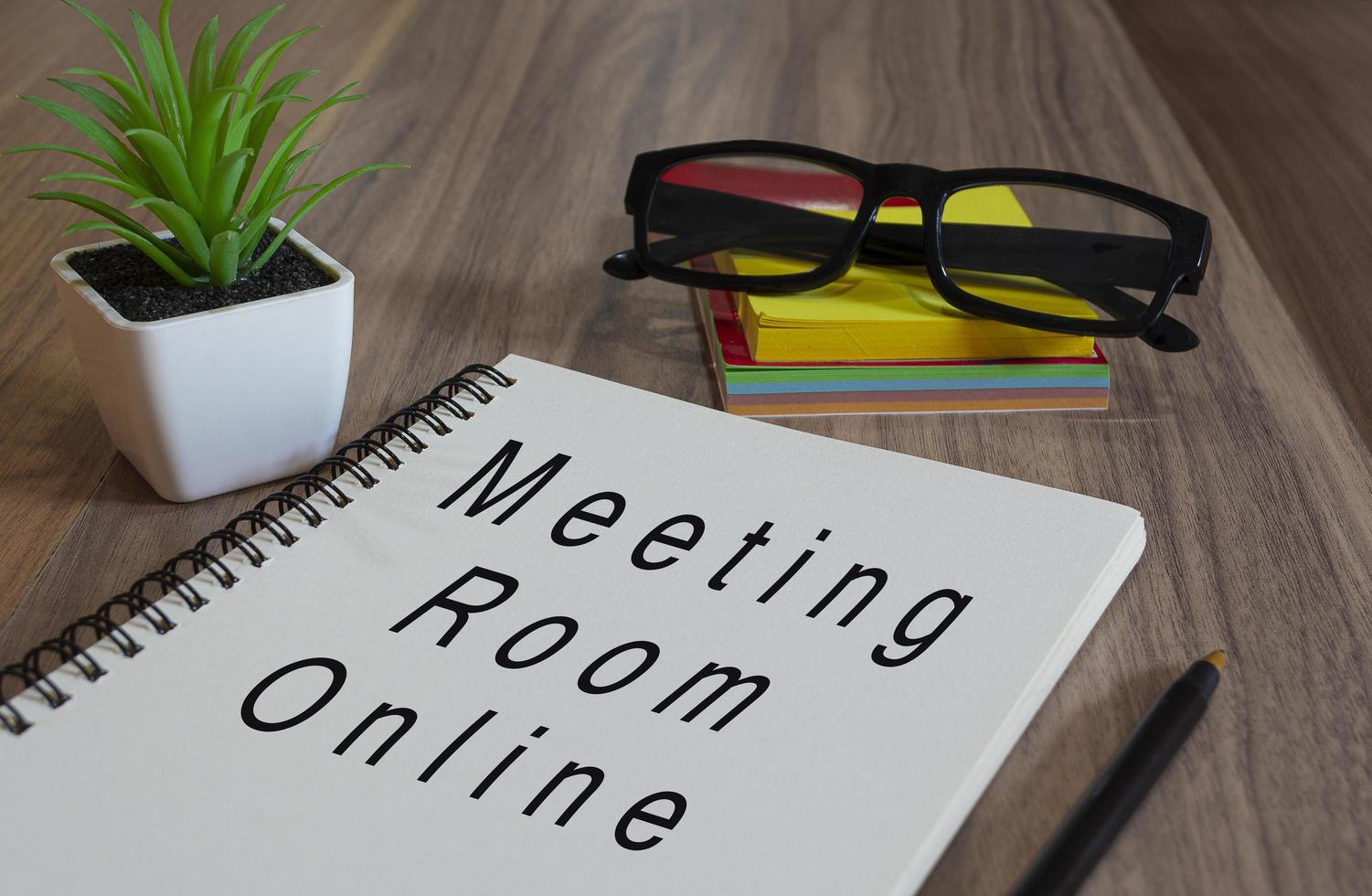 Text on white notepad wooden desk - Meeting room online. Business concept photo