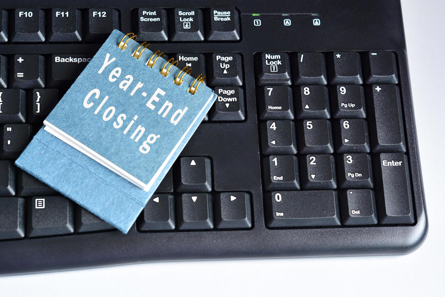 Text on calendar page on blue keyboard - Fiscal year end closing photo