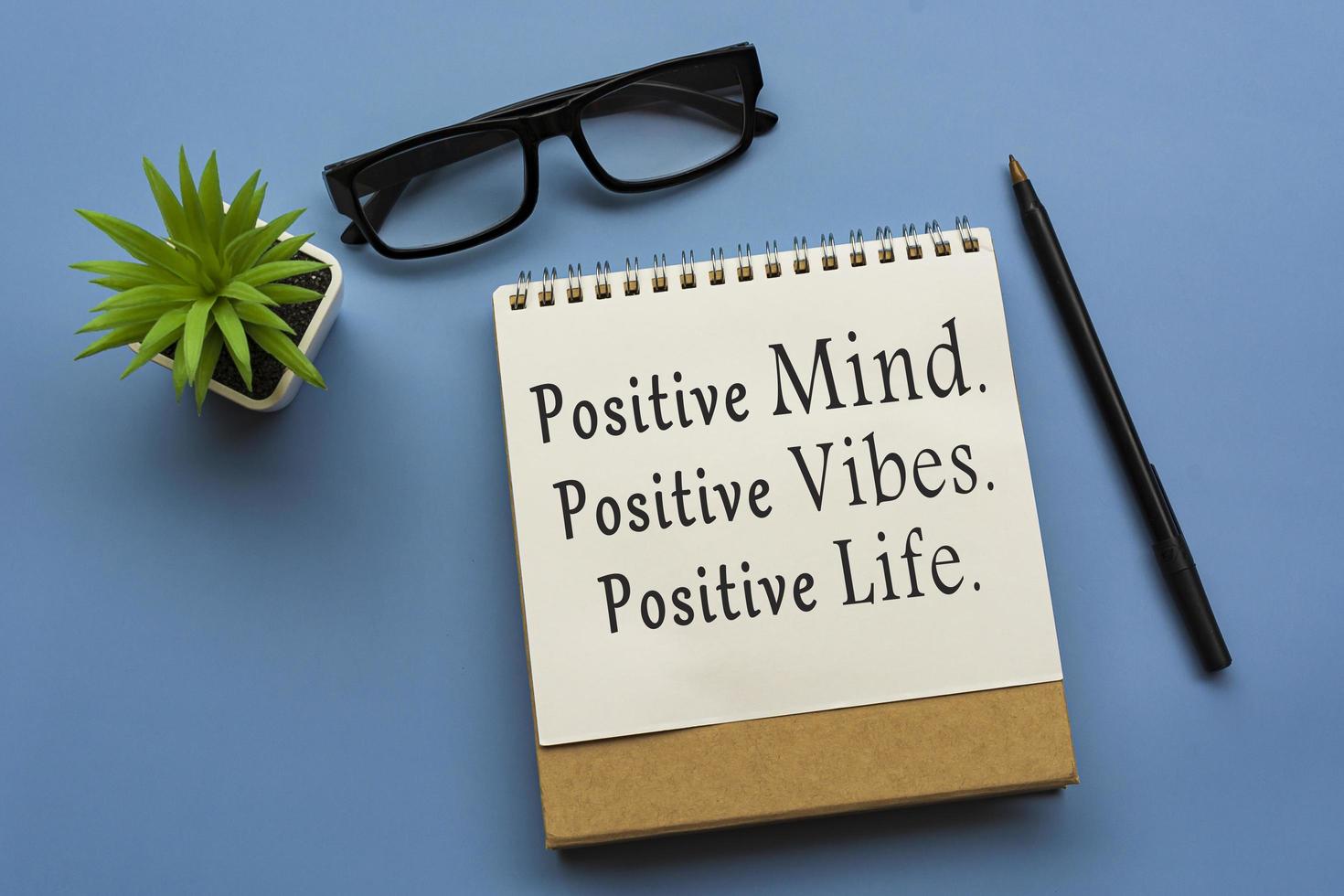 Motivational quote on notepad - Positive Mind, Positive Vibes, Positive Life. photo