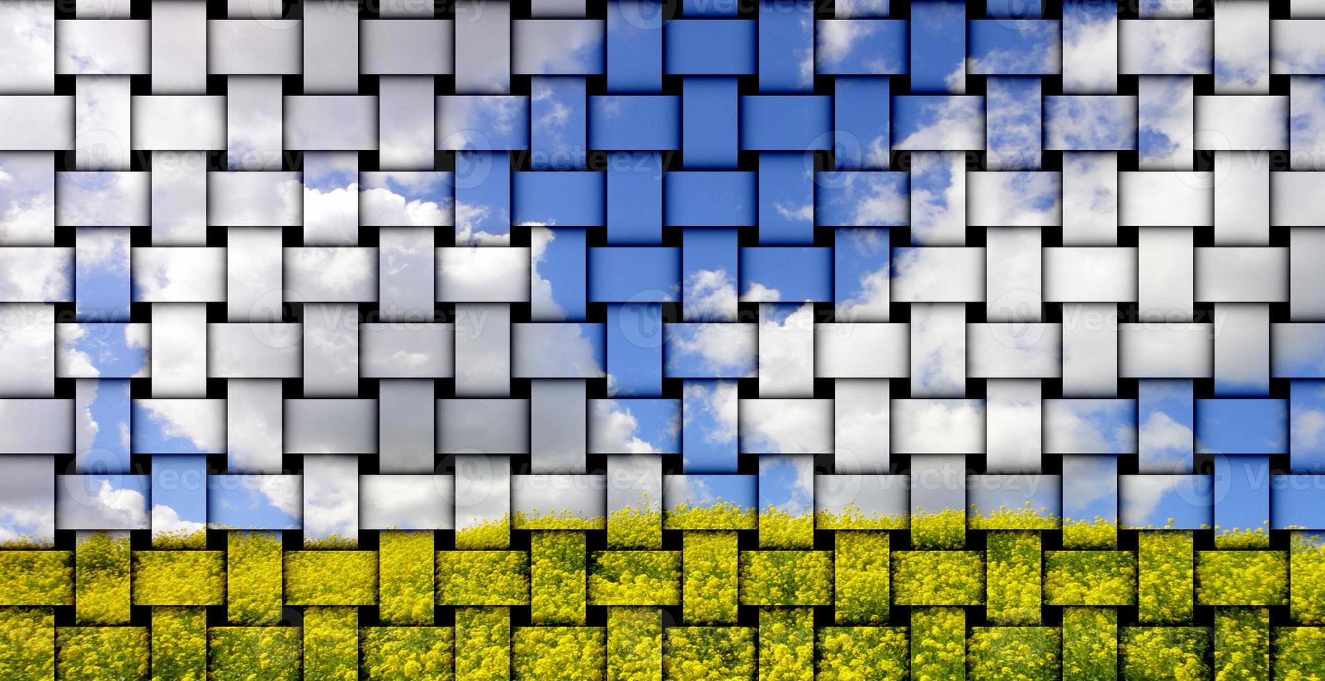 Woven fabric depicting a blue sky with cumulus clouds and yellow-green grass. photo
