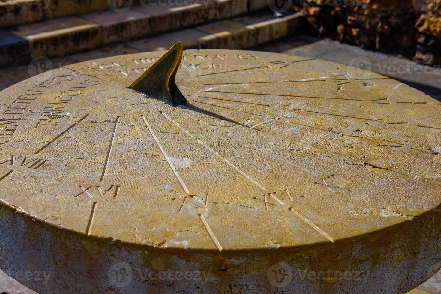 a clock that casts a shadow from the time of the Roman Empire. photo