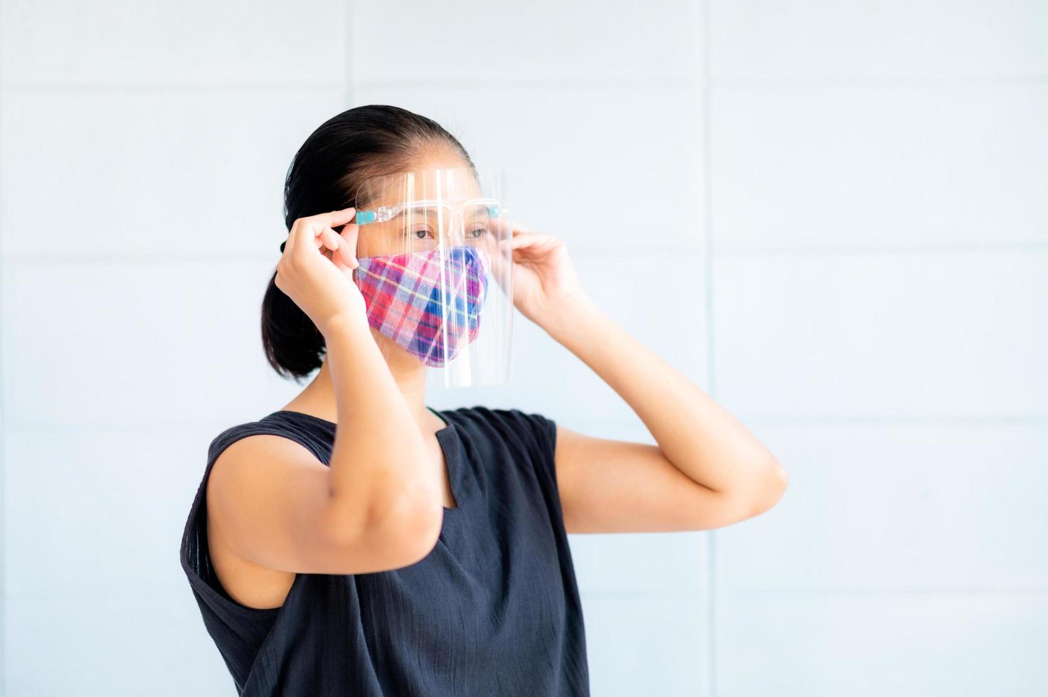 Asian women have to use masks and face shields to protect against pollution from dust and to prevent infections from secretions that spread in the air photo