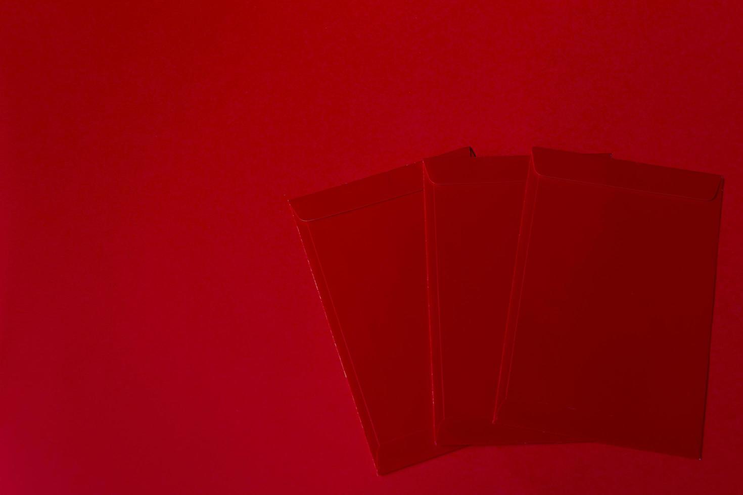 Red packets on red background - Chinese New Year Concept photo