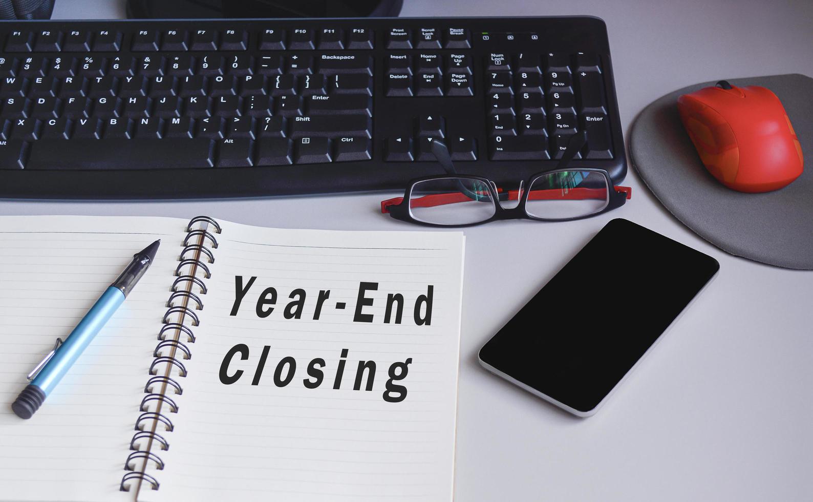 Text on notepad on a desk Year end closing. Audit and accounting