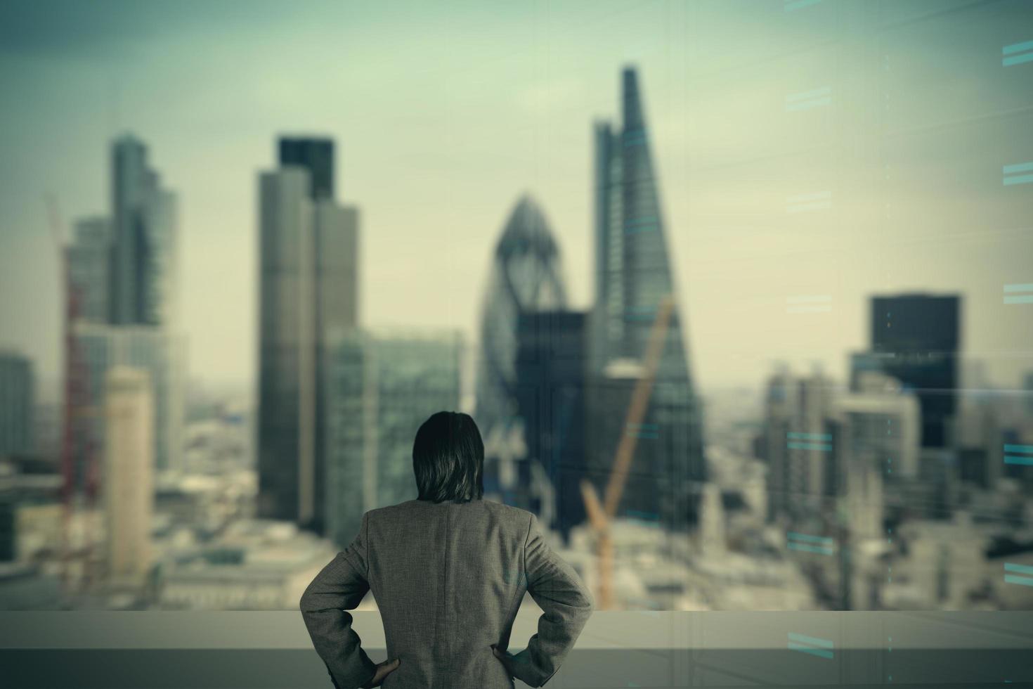 businessman stands successfully on building top Looking Towards the future photo