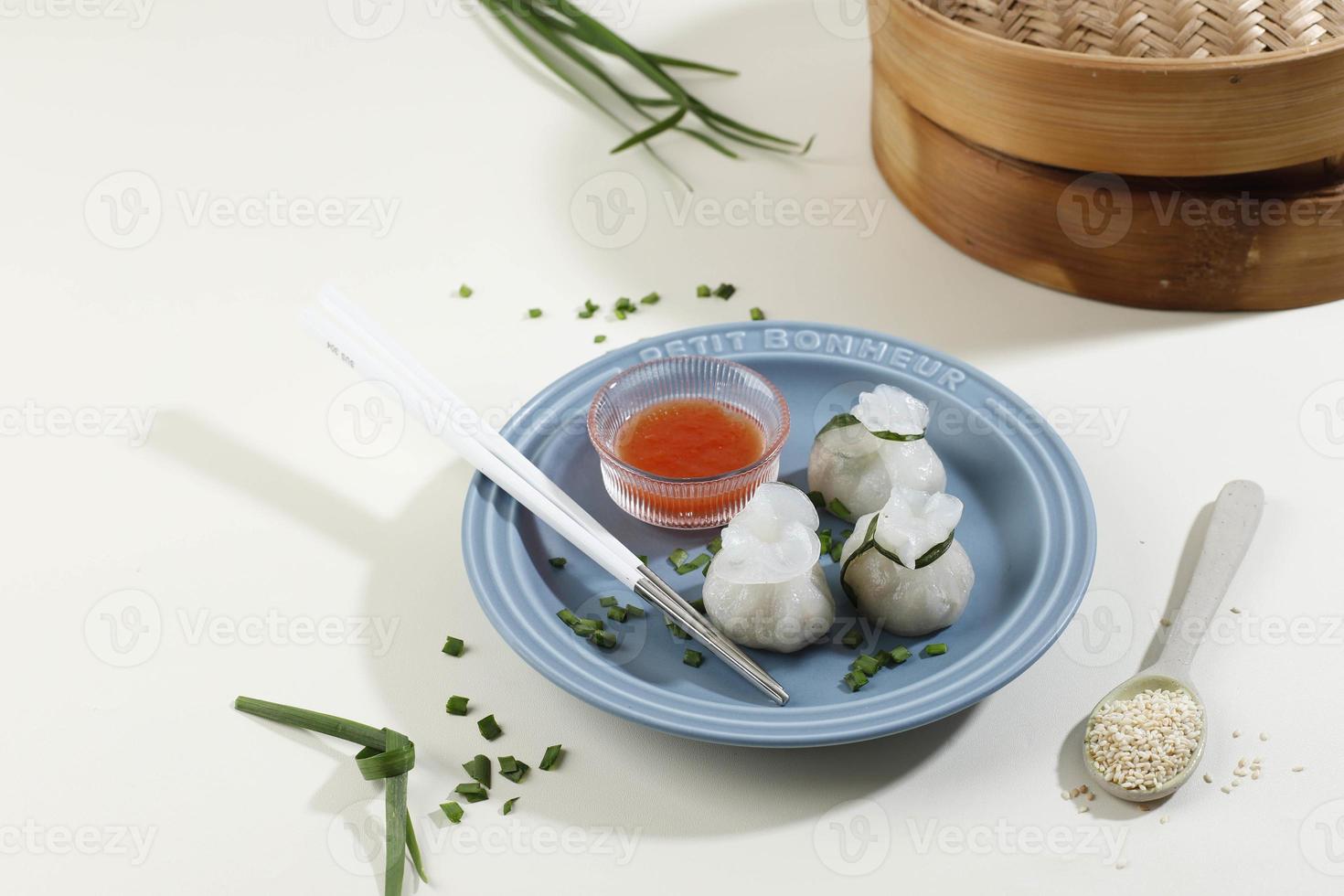 Chives Dumpling on Blue Plate and Bamboo Steamer, Copy Space for Text photo