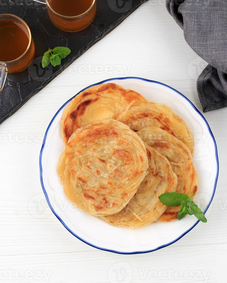 Roti Canai or Paratha on White Table photo