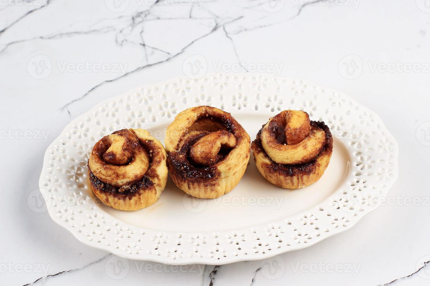 Beautiful Fresh Cinnamon Rolls Close Up on White Table. Fragrant Homemade Cakes photo