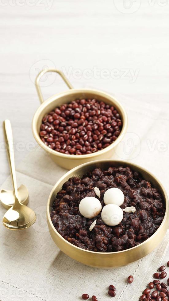 Korean Food Patjuk or Red Bean Porridge Topped with Round Rice Cake, Eat at Winter Solstice Festival photo