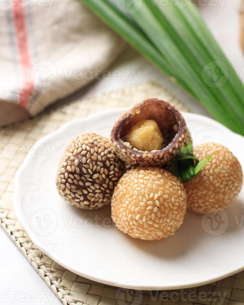 Onde-onde or Glutinous Rice Sesame Seed Ball, Served on Indonesian Traditional Style Bali Plate. Close Up. photo