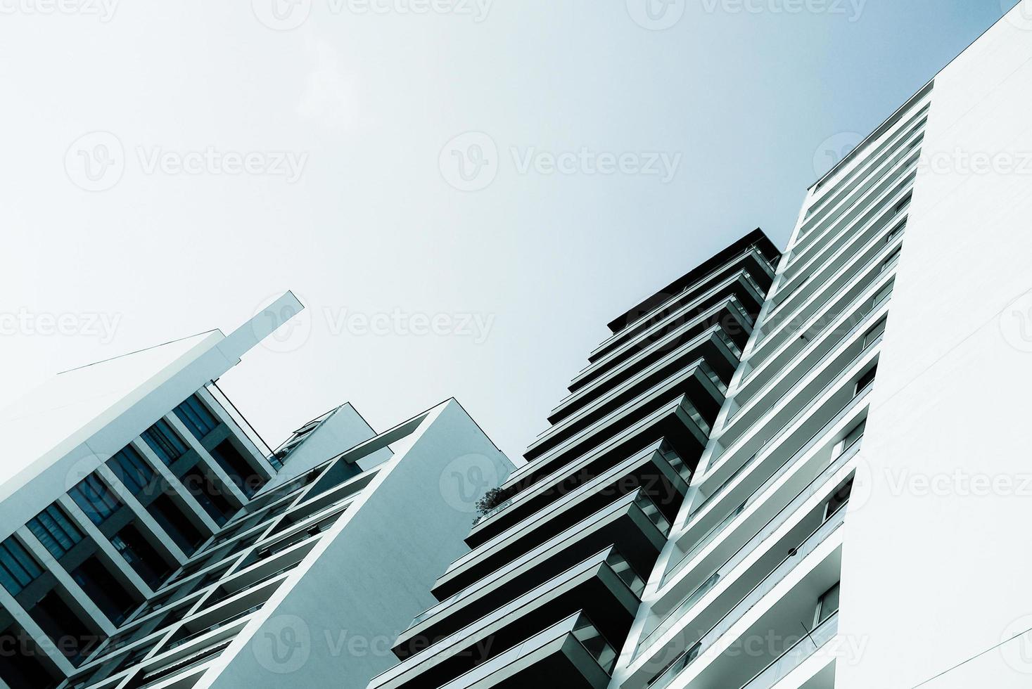 Blue monochrome image of modern multistory residential buildings photo