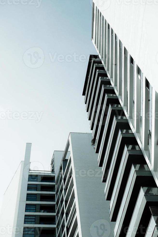 Blue monochrome image of modern multistory residential buildings photo