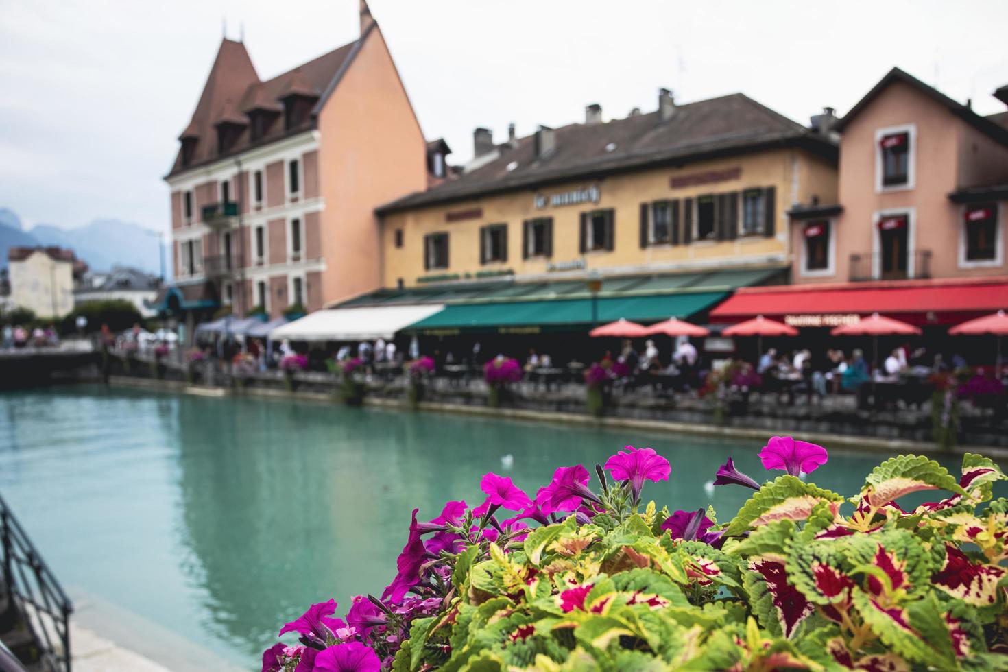 the view of city canal with medieval buildings in Annecy Old Town, Restaurant near the River Thou in Old Town,The building looks great in middle of a large city. photo