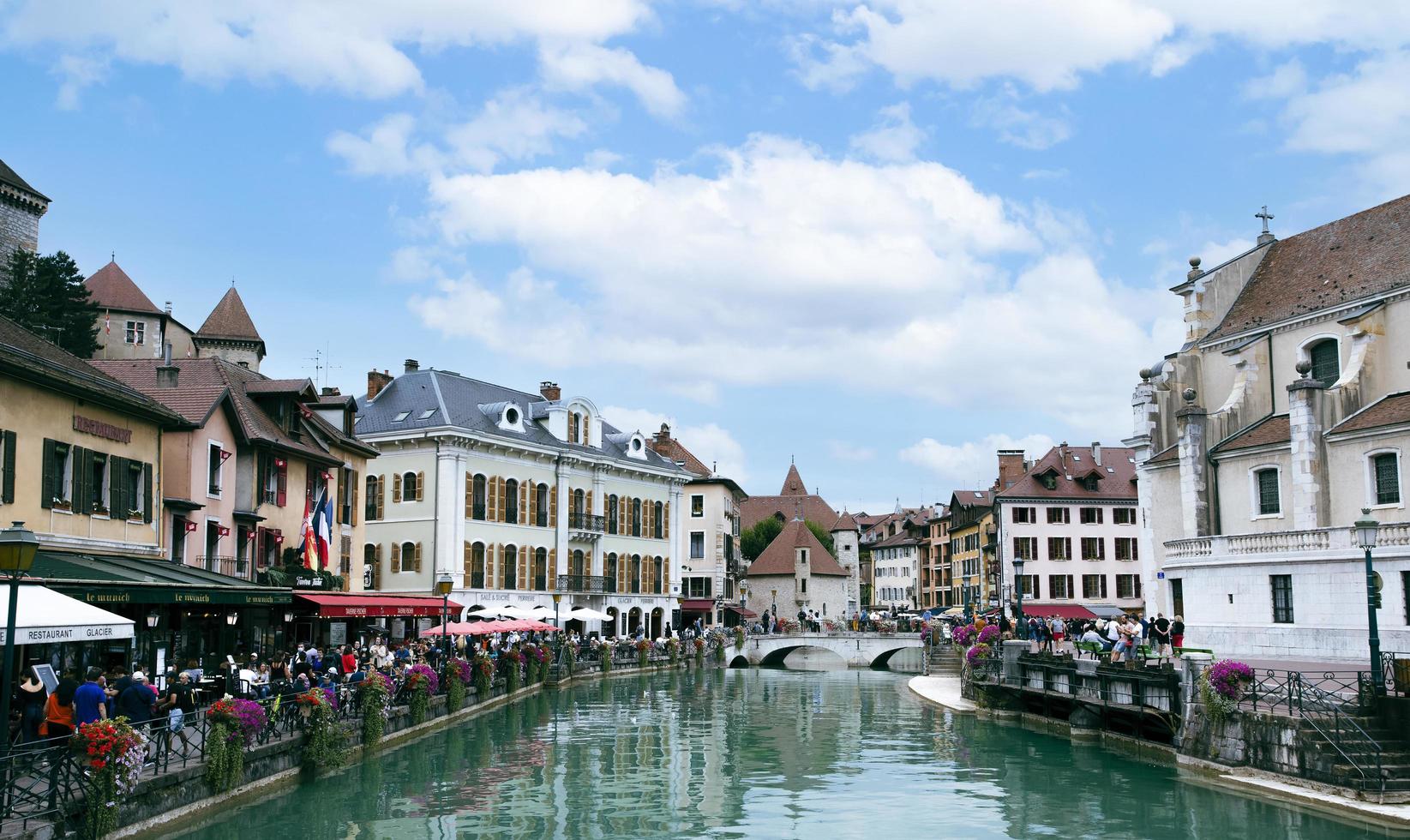 the view of city canal with medieval buildings in Annecy Old Town, Restaurant near the River Thou in Old Town,The building looks great in middle of a large city. photo