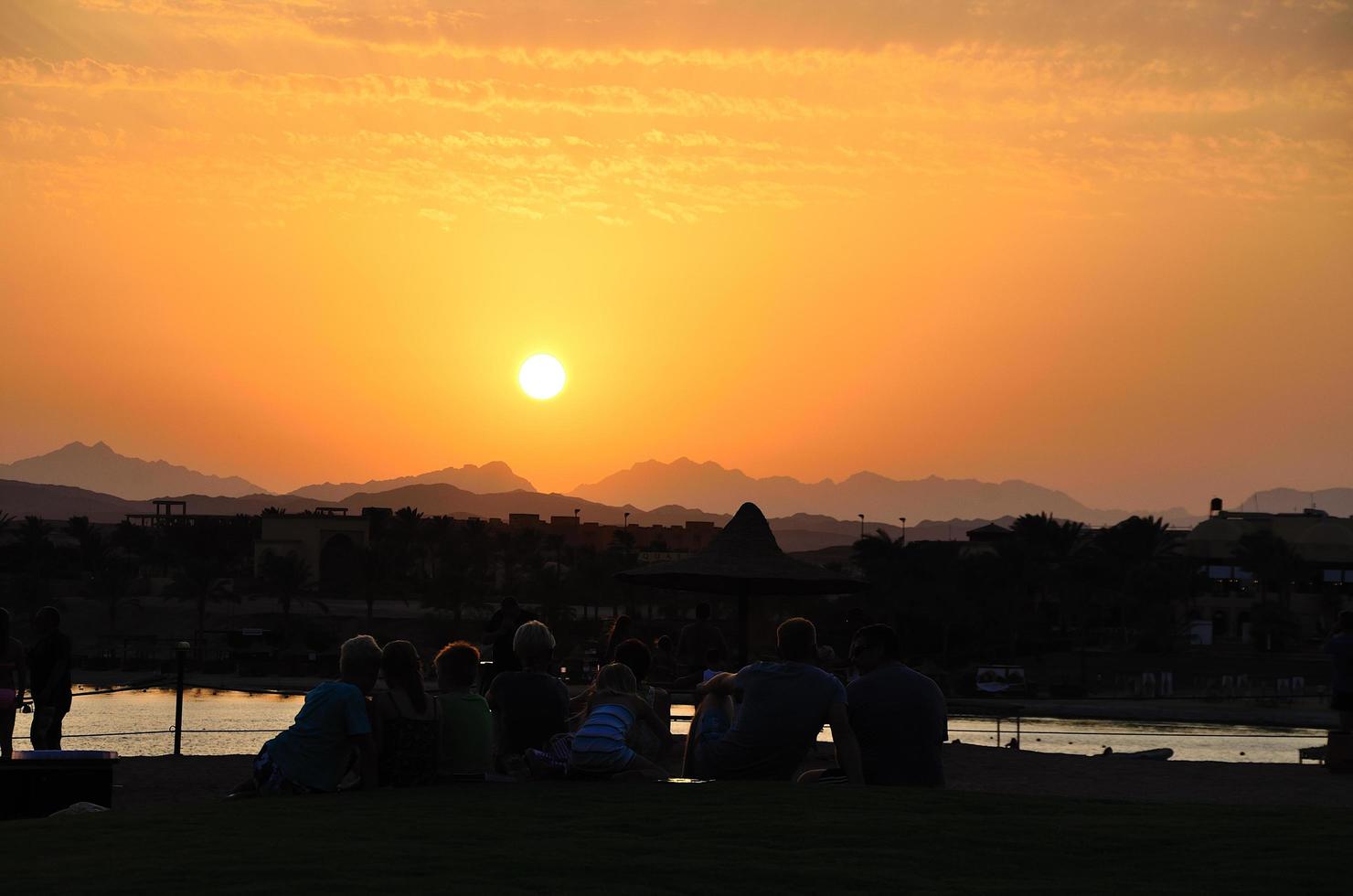 la gente mira la puesta de sol foto