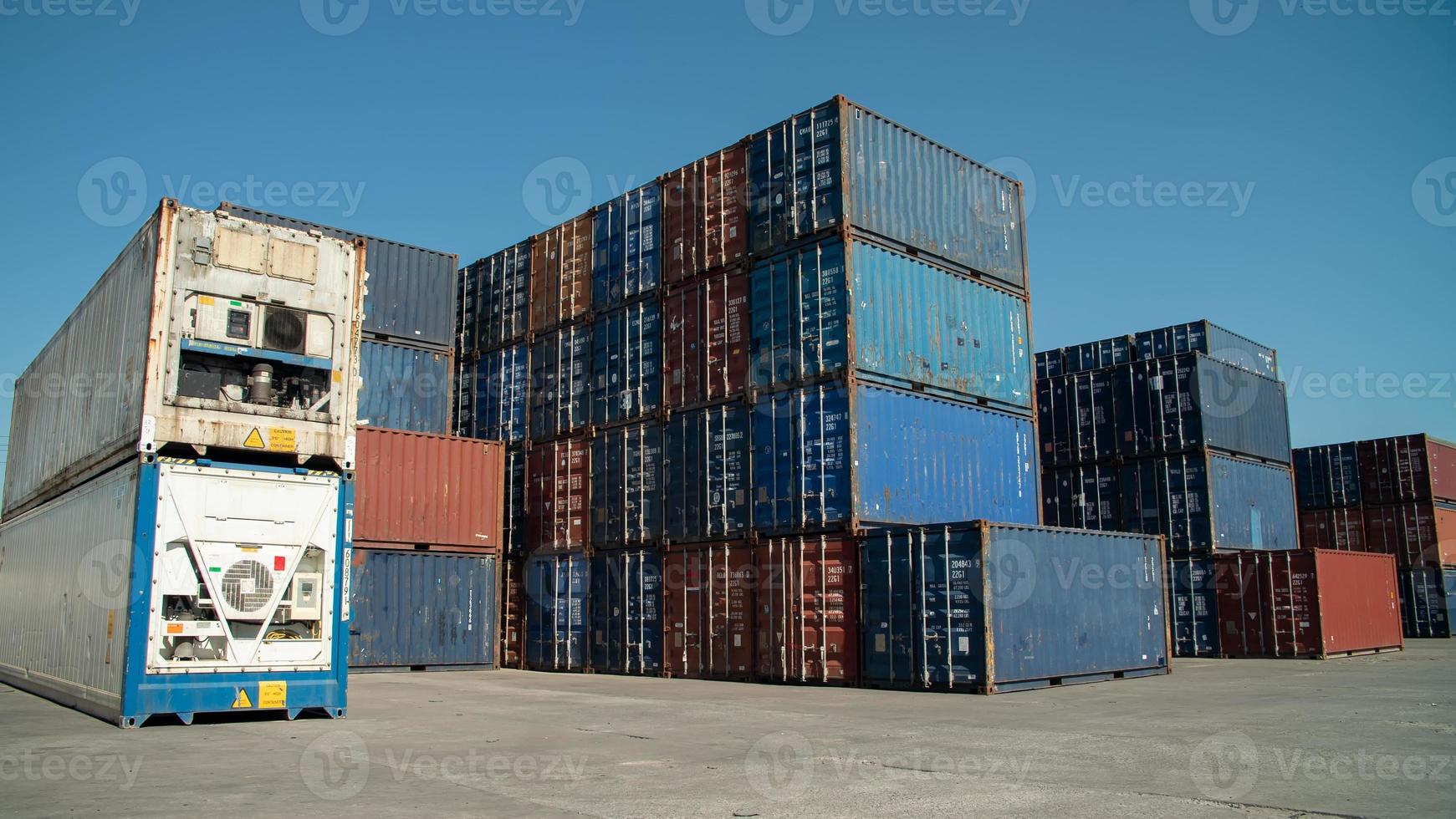 Foreman control loading Containers box from Cargo freight ship for import export. photo