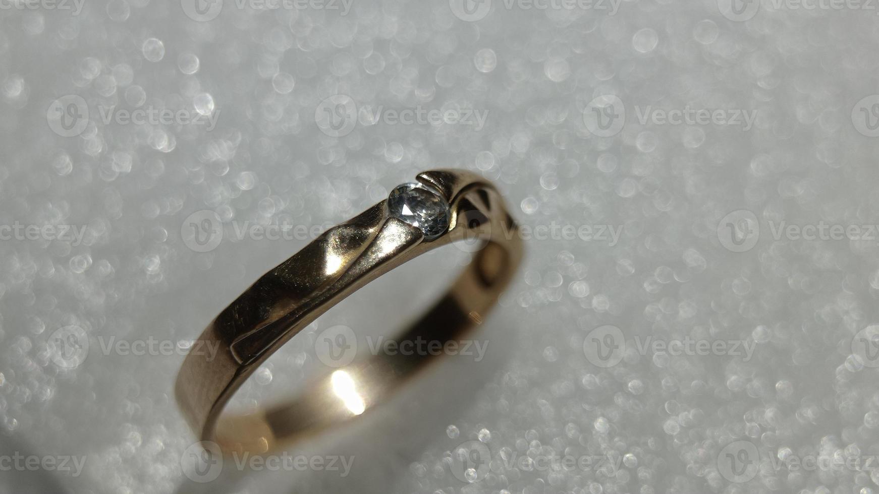 Beautiful gold ring on white background natural blur photo