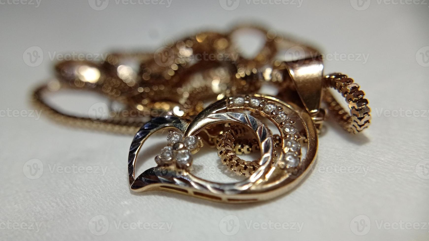 Close up shot of gold jewelery on a blurry white background photo