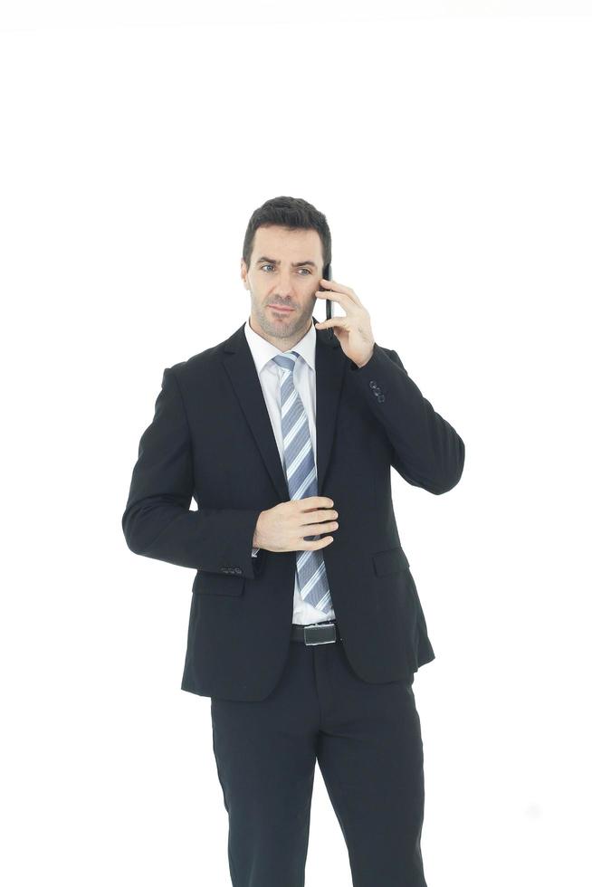 Handsome businessman in a suit hand holding smartphone and talking on the phone isolated on white background.Copy Space photo