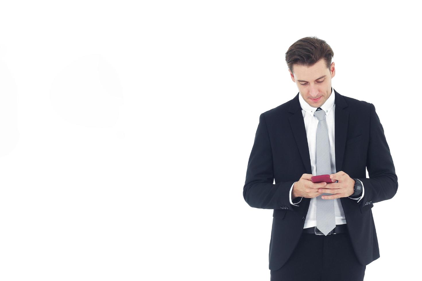 Handsome businessman in a suit hand holding smartphone isolated on white background.Copy Space photo