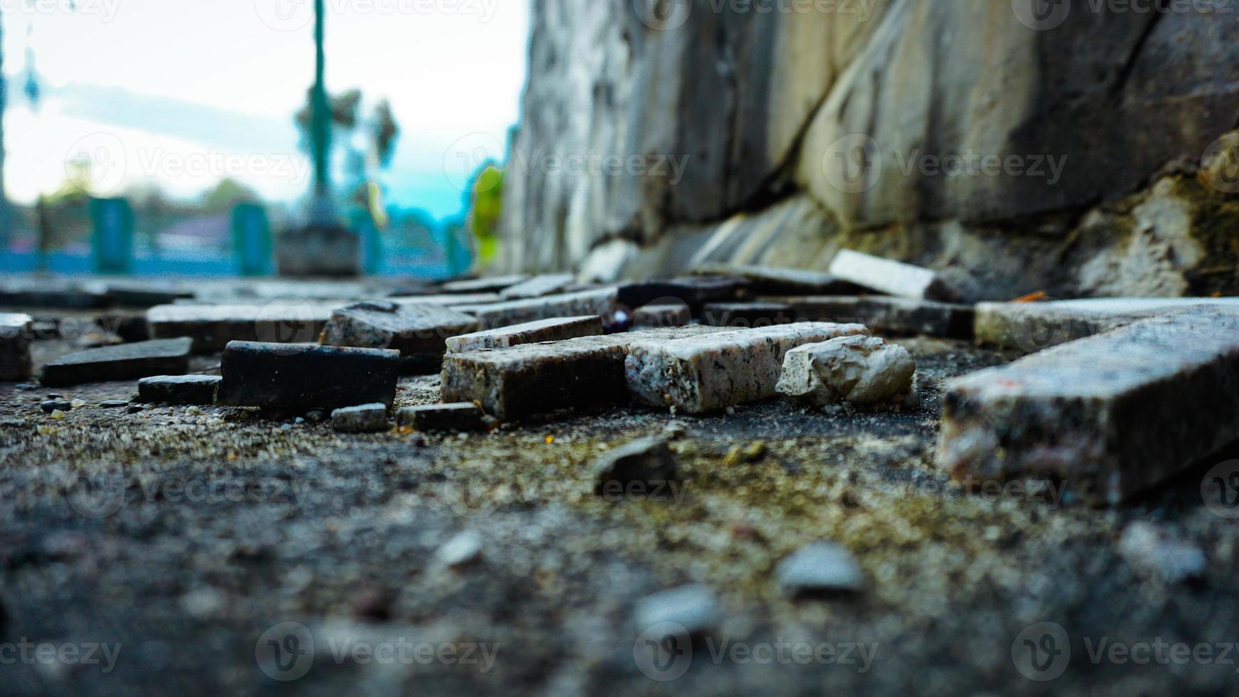 a pile of bricks scattered on the ground photo