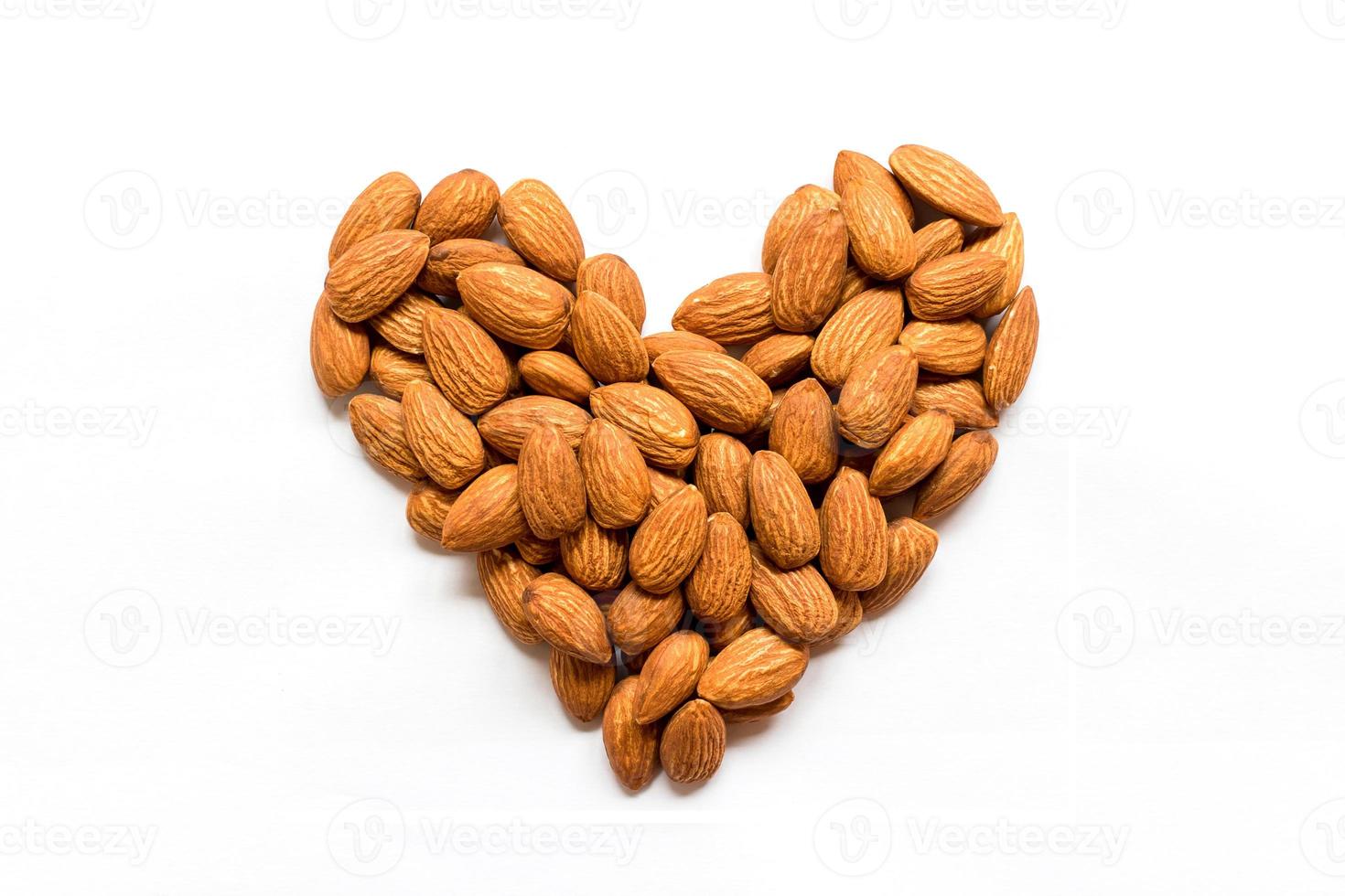 Almonds heart shape pattern isolated on white background with blank.Love valentine's day concept. photo