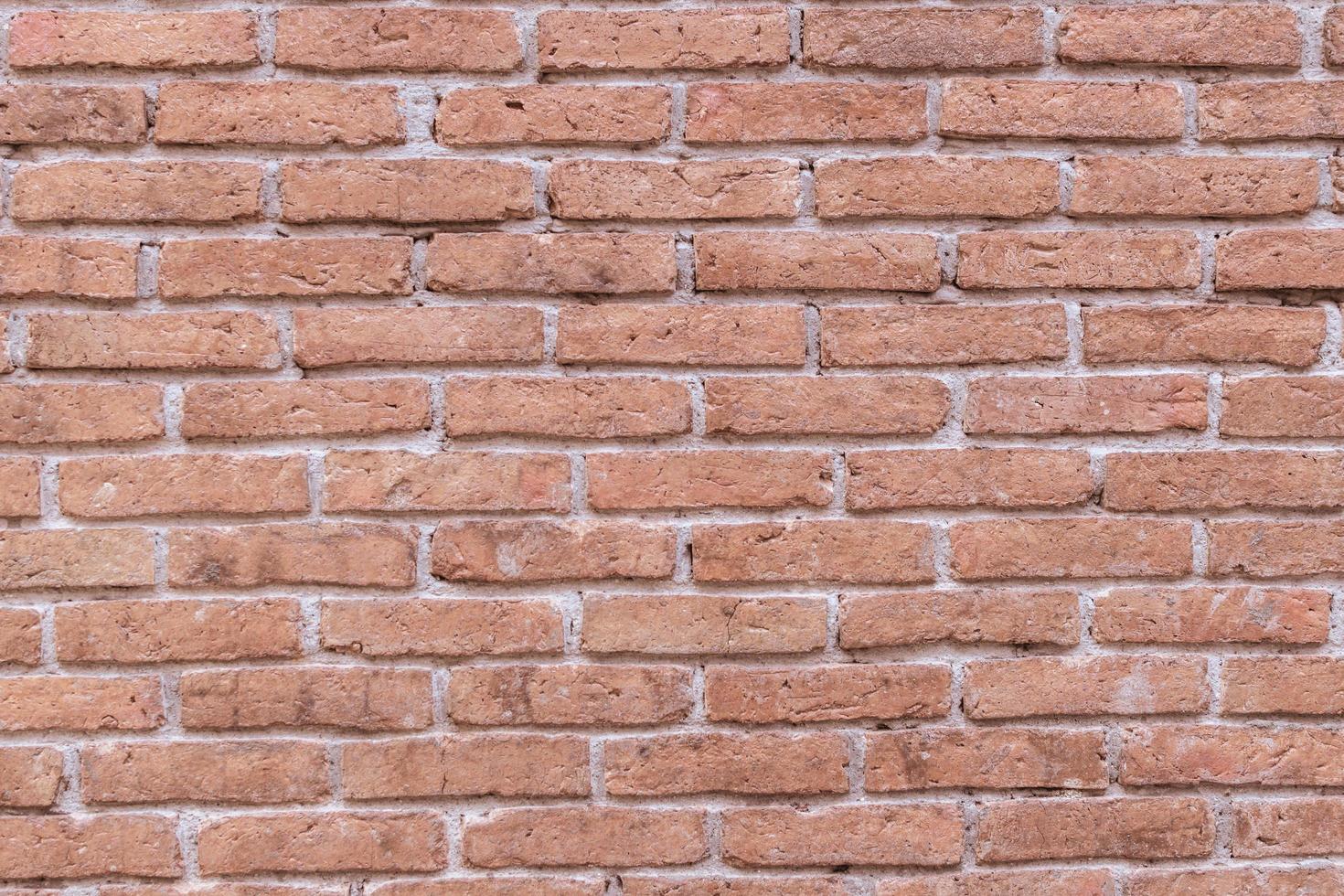 Old grungy red brick wall block pattern and cement surface background.Vintage wallpaper.Rustic stonewall.Brickwork. photo